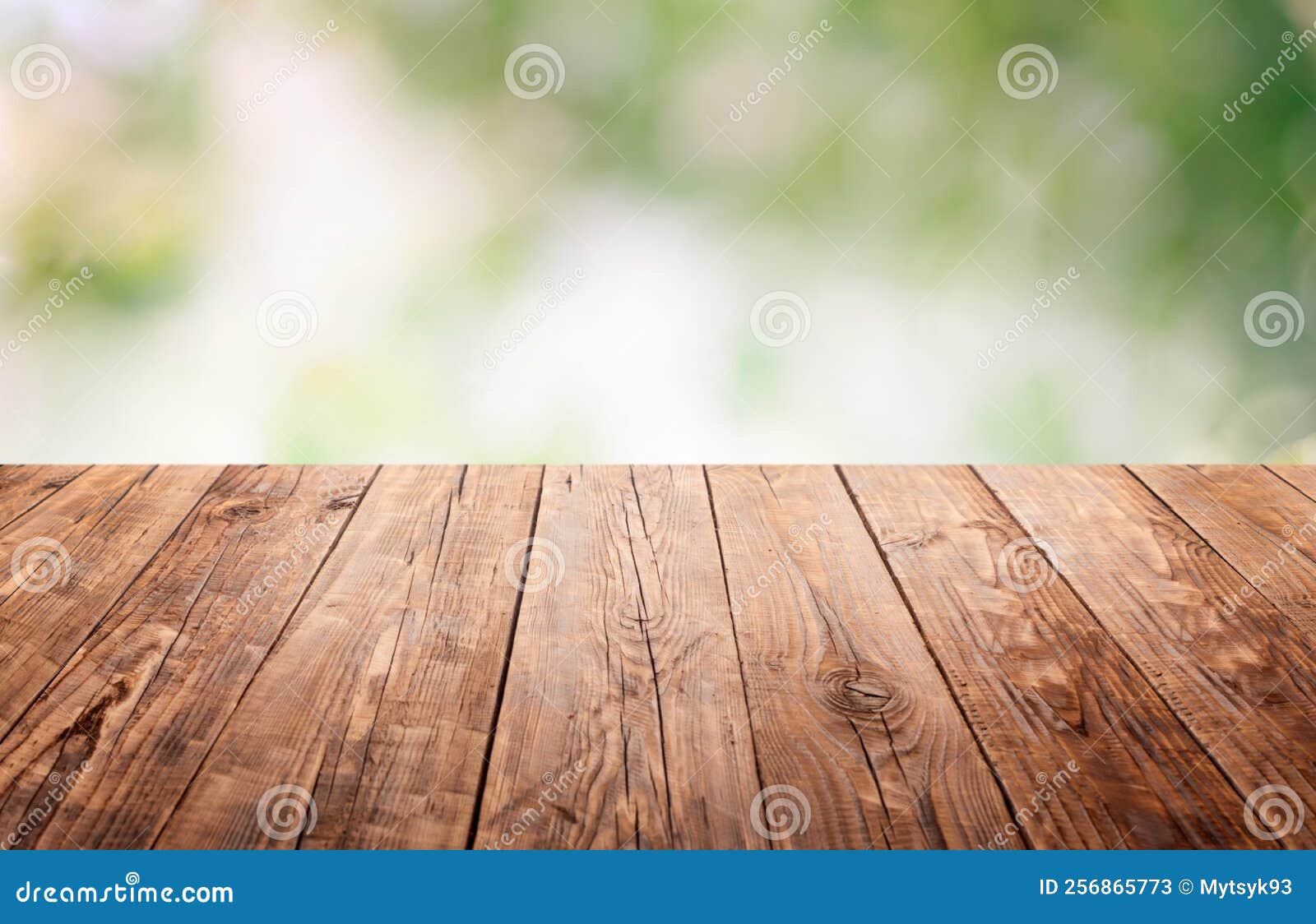 Empty Wooden Brown Tabletop with a Blurry, Defocused Garden. Summer is
