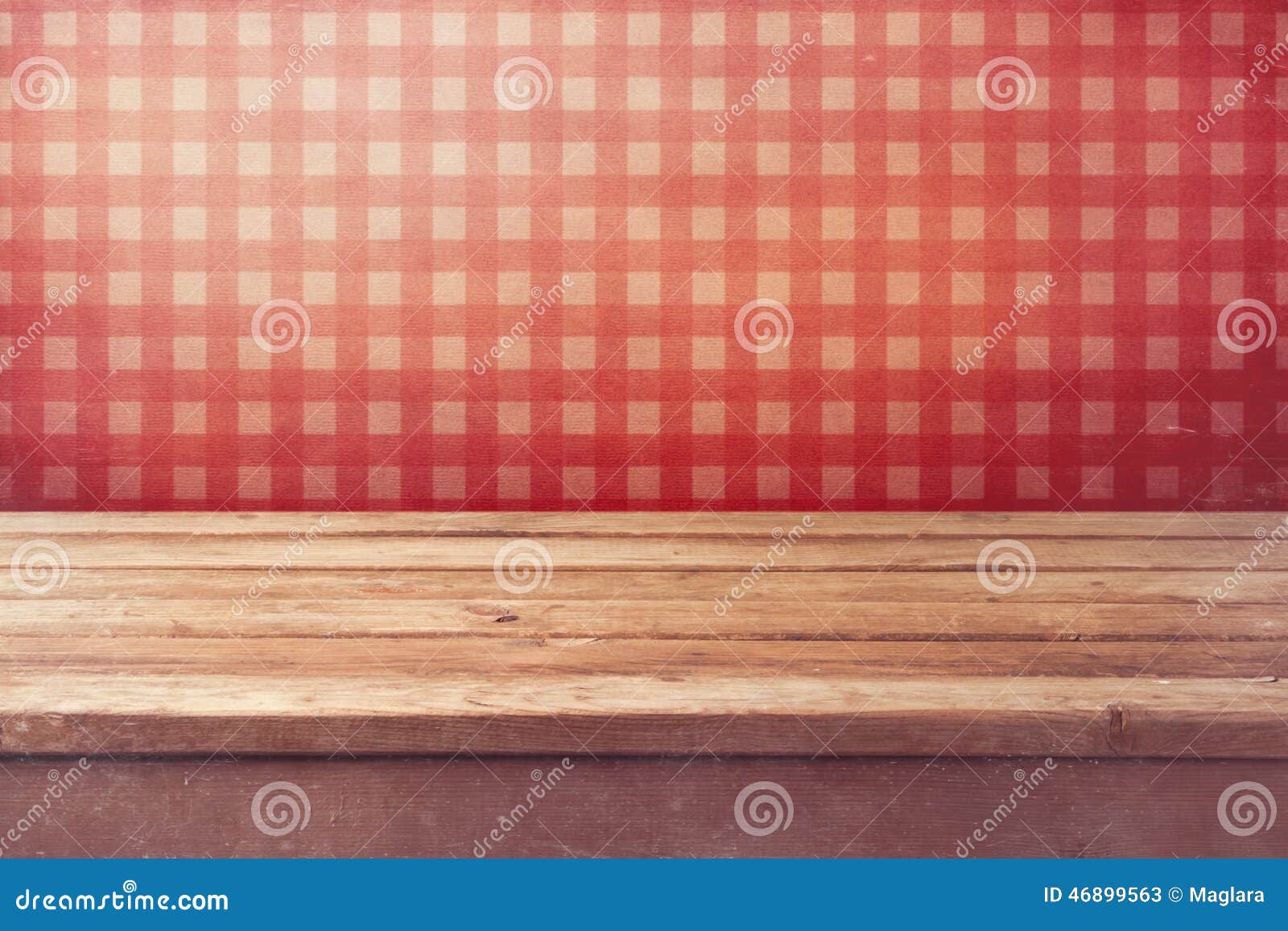 empty wooden deck table over checked red wallpaper. vintage kitchen interior.