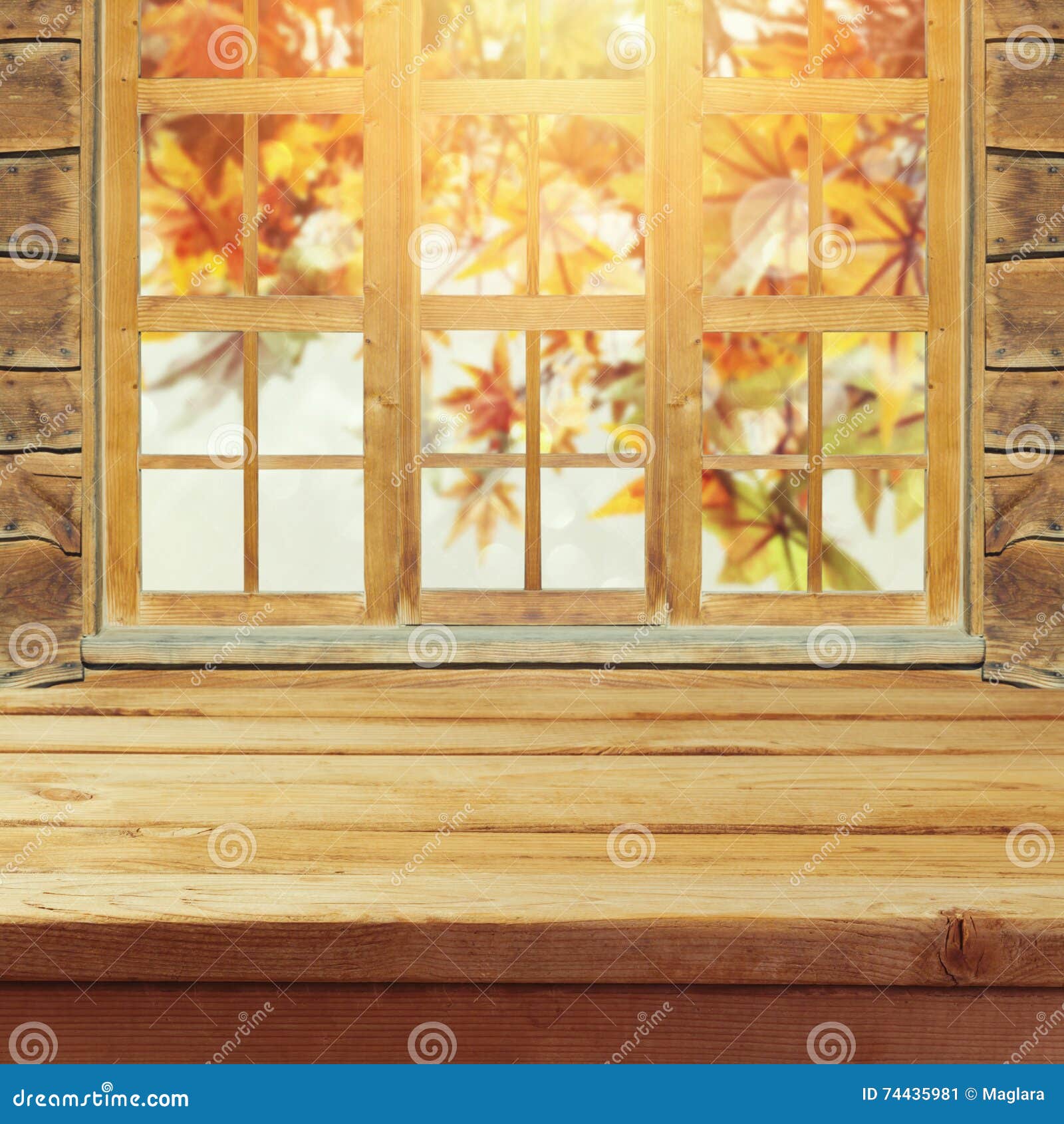 empty wooden deck table over wndow and autumn leaves bokeh background