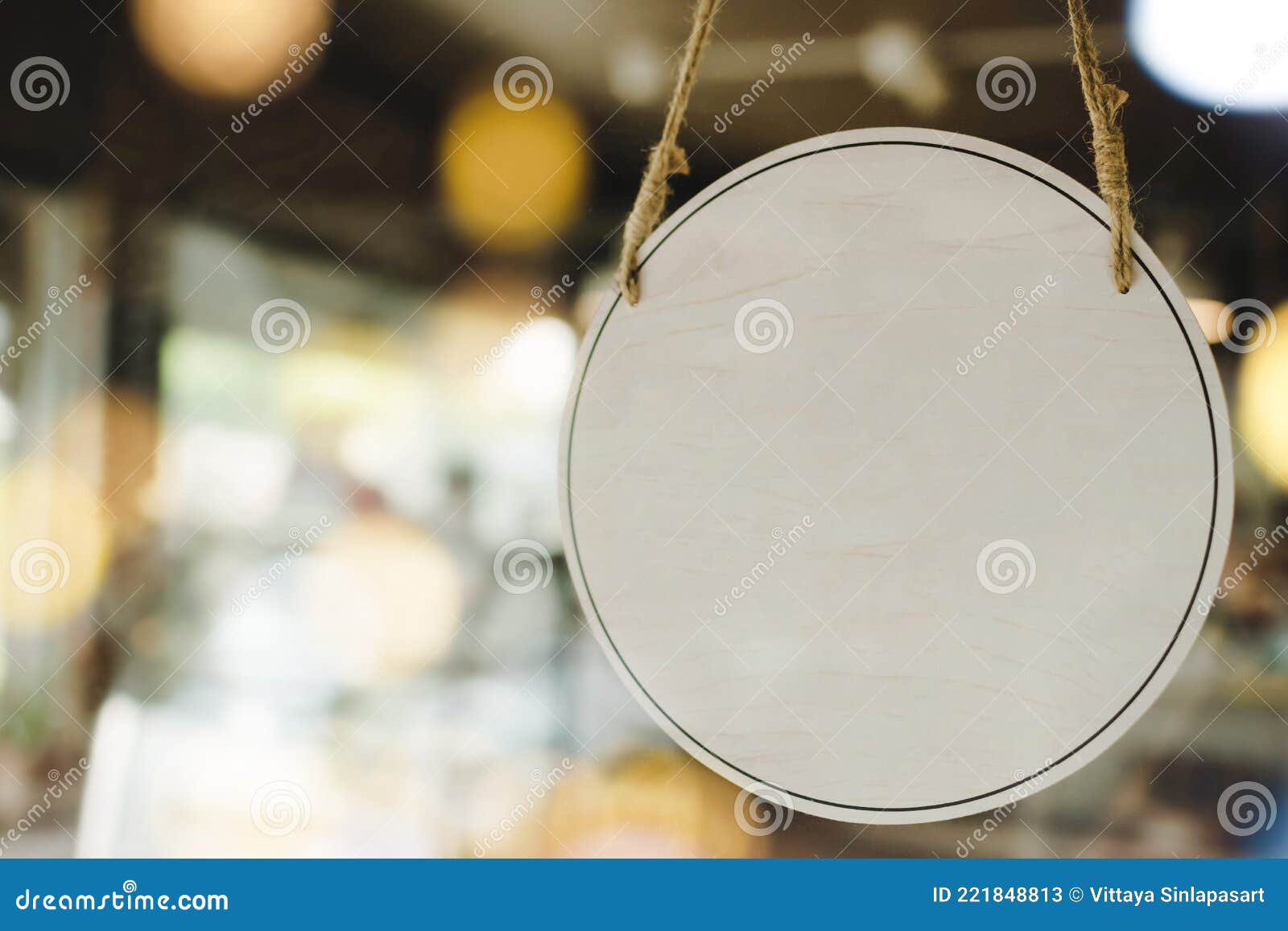 empty wooden sign board hanging on glass door with bokeh light in modern cafe restaurant, copy space for text advertising, cafe re