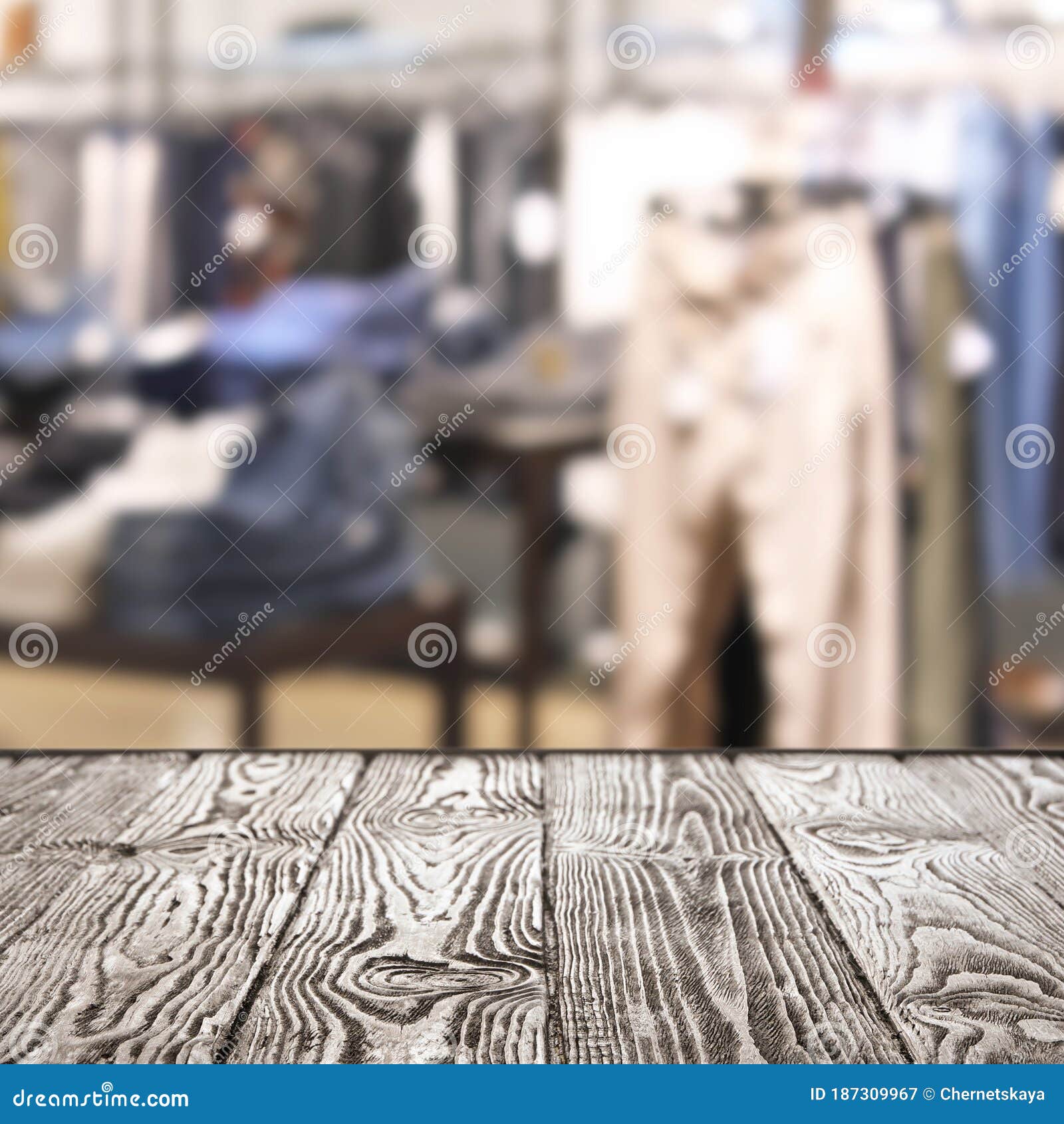 Empty Table and Blurred View of Store with Modern Clothes Stock Image