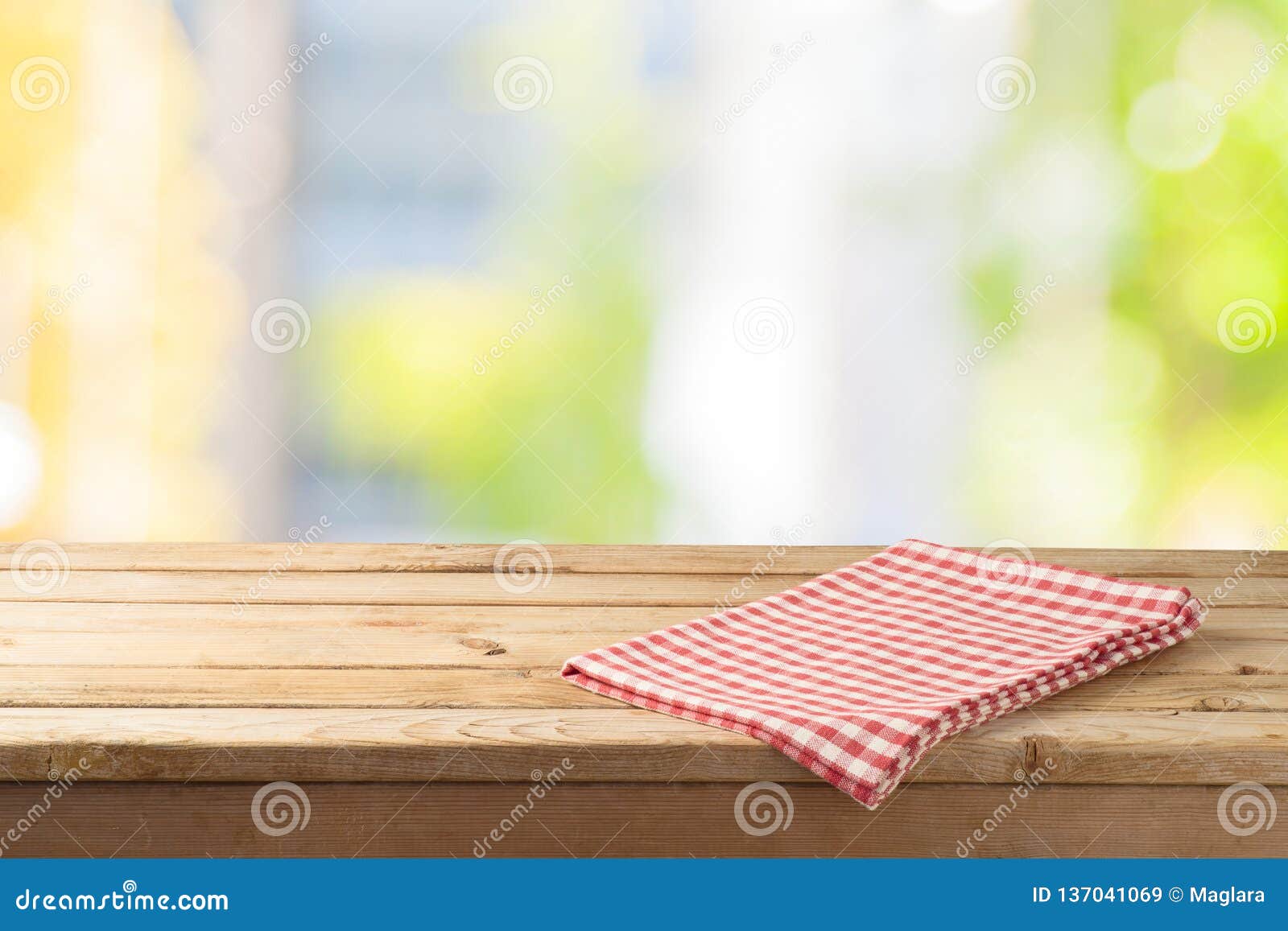 empty wooden table with table cloth over abstract bokeh background