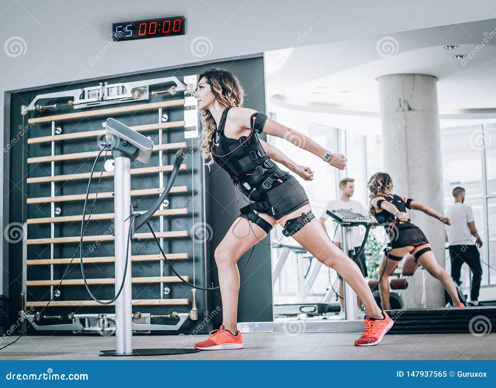 EMS Electro Stimulation Women Exercises with Coach in Modern Gym Stock  Image - Image of fitness, personal: 147937565