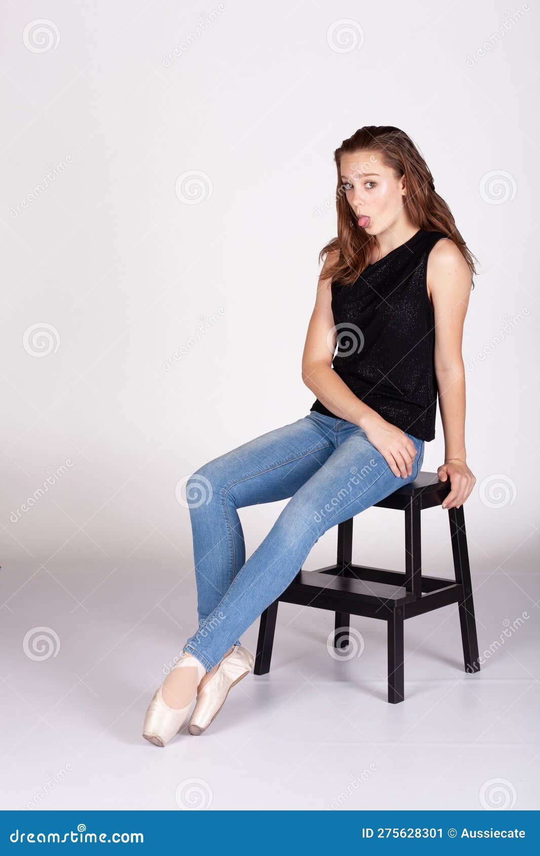 en pointe resting on stool legs extended tounge out