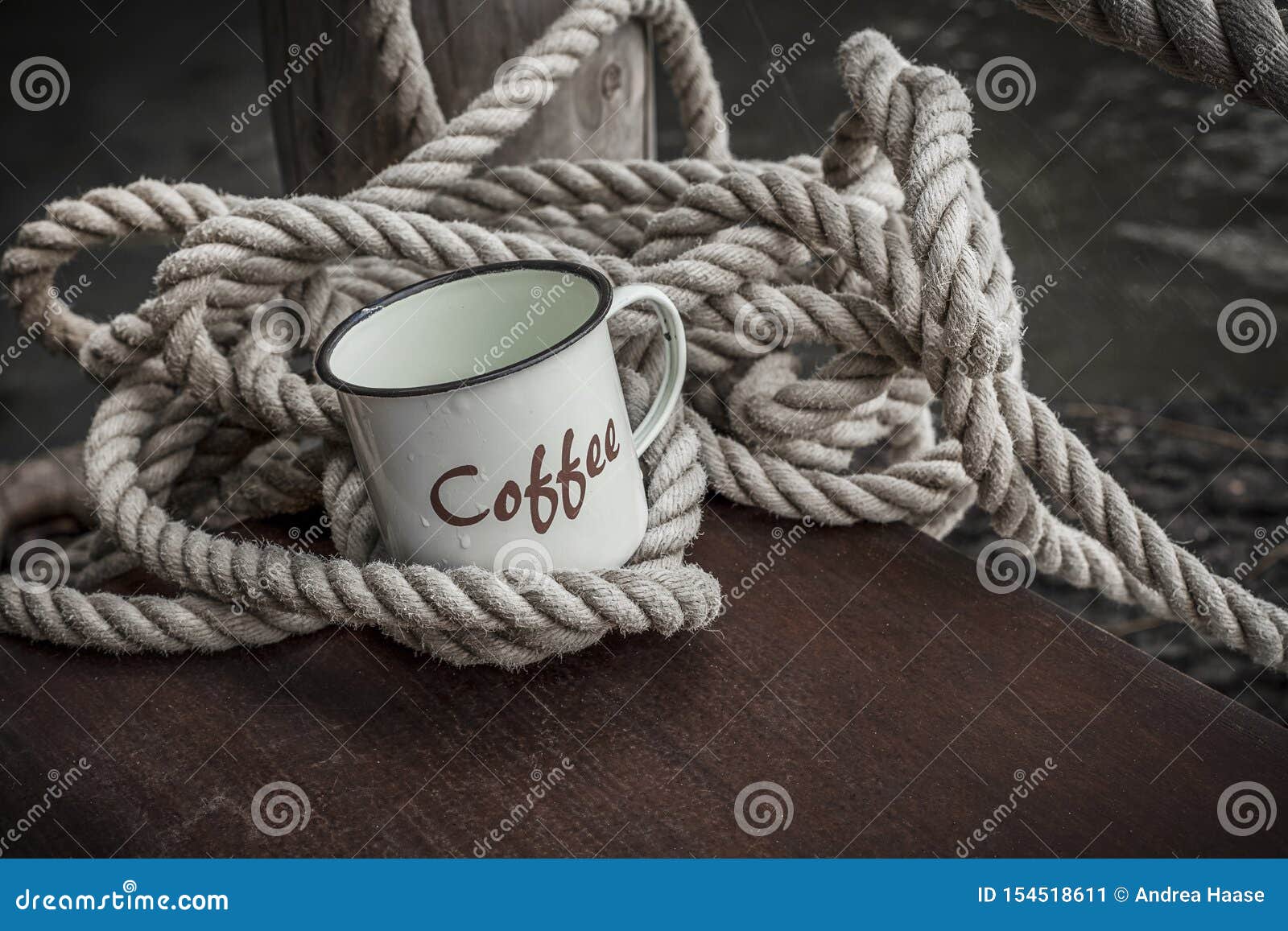 https://thumbs.dreamstime.com/z/enamel-coffee-mug-rope-rustic-cup-word-decorative-thick-wooden-jetty-water-s-edge-154518611.jpg