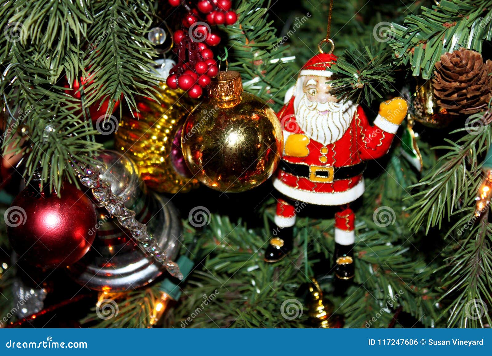 Enamel Santa Claus and Other Ornaments on Traditional Christmas Tree ...