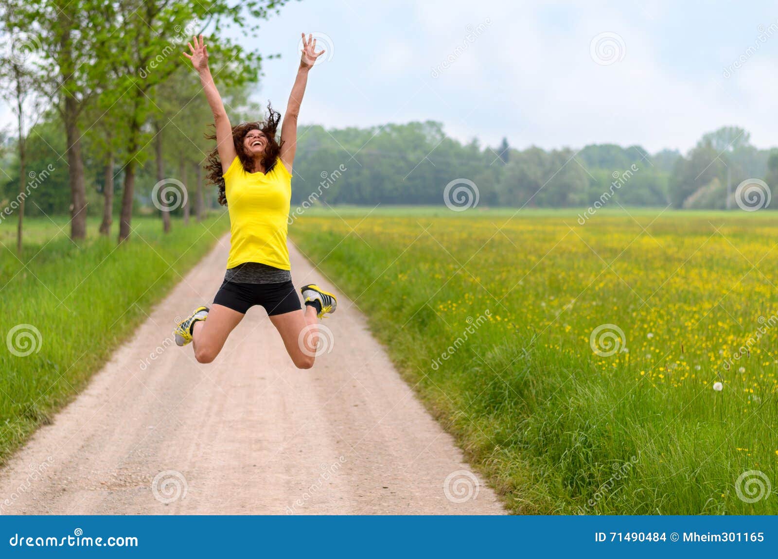 energetic agile young woman leaping for joy