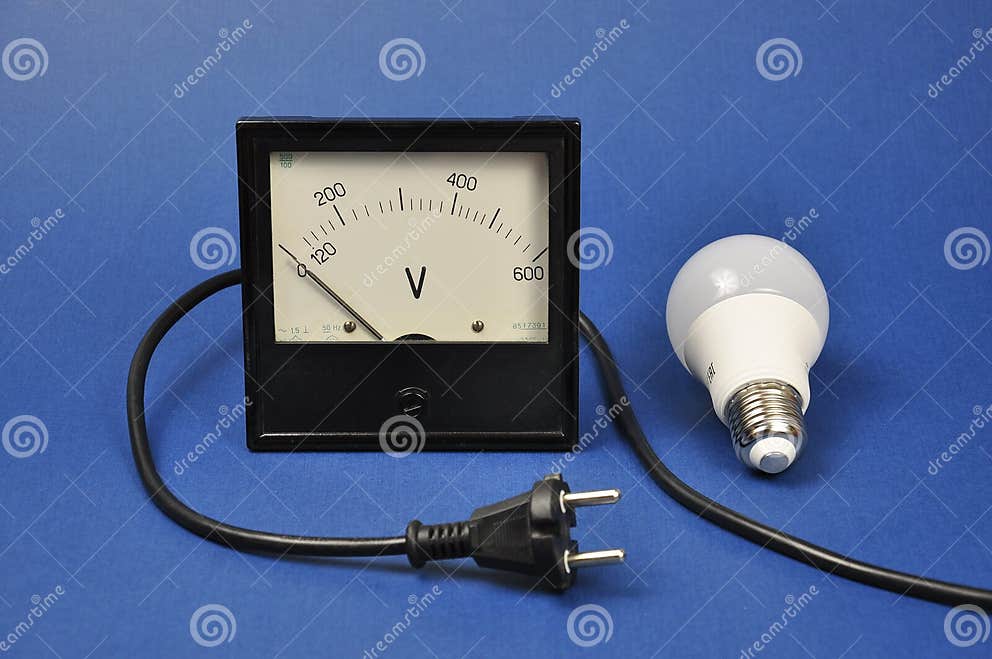 Energysaving Light Bulb and Analog Voltmeter. the Concept of Energy Saving Stock Photo Image