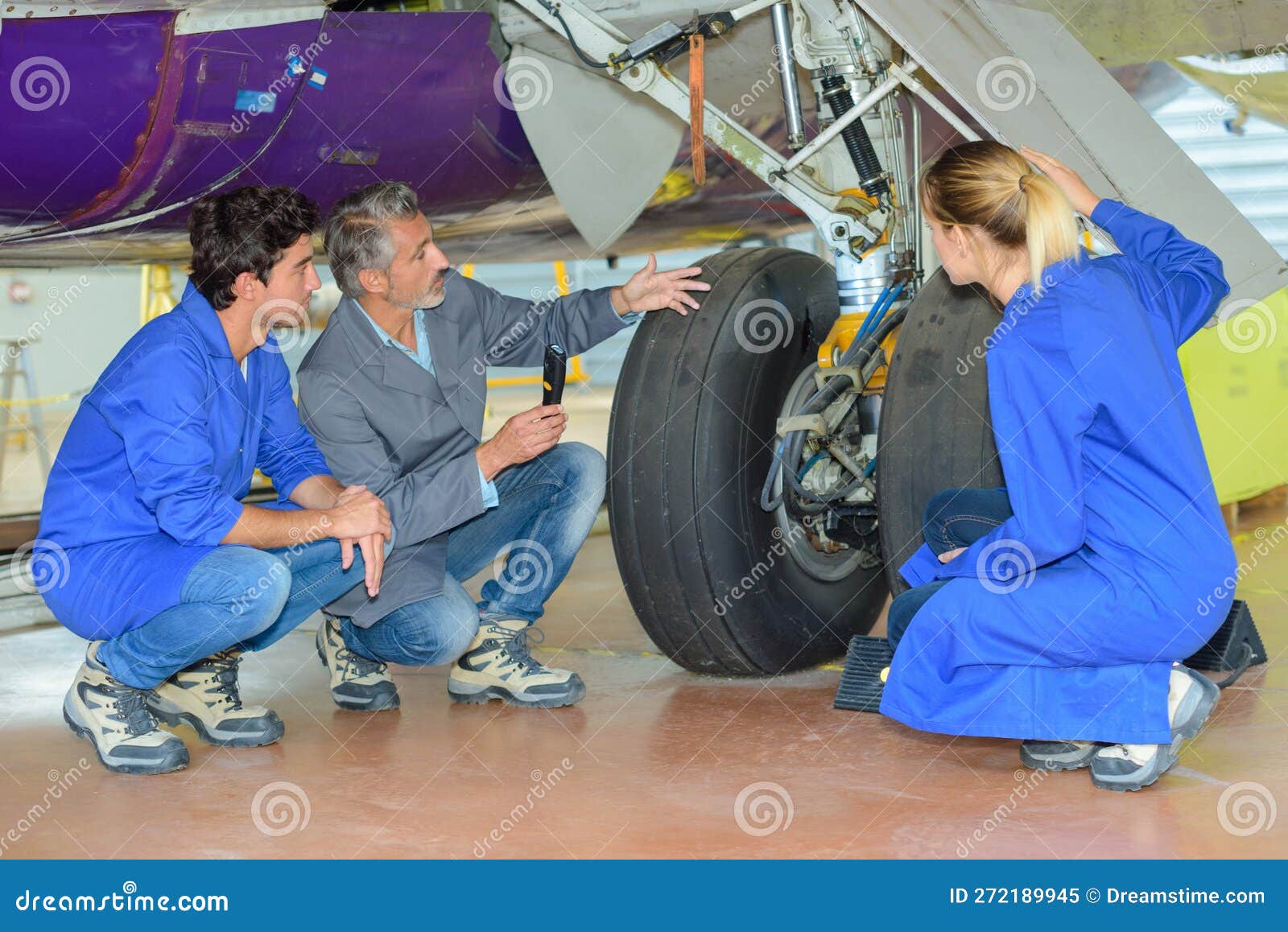 Engineer and Apprentices Checking Airplane Wheels Stock Image Image