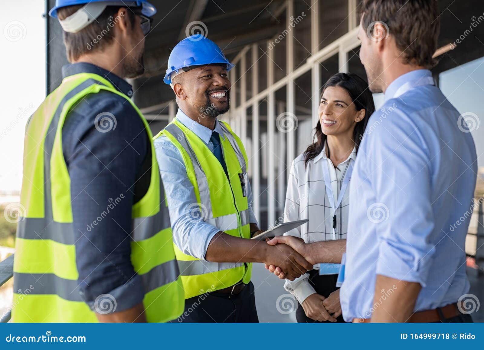 engineer and businessman handshake at construction site