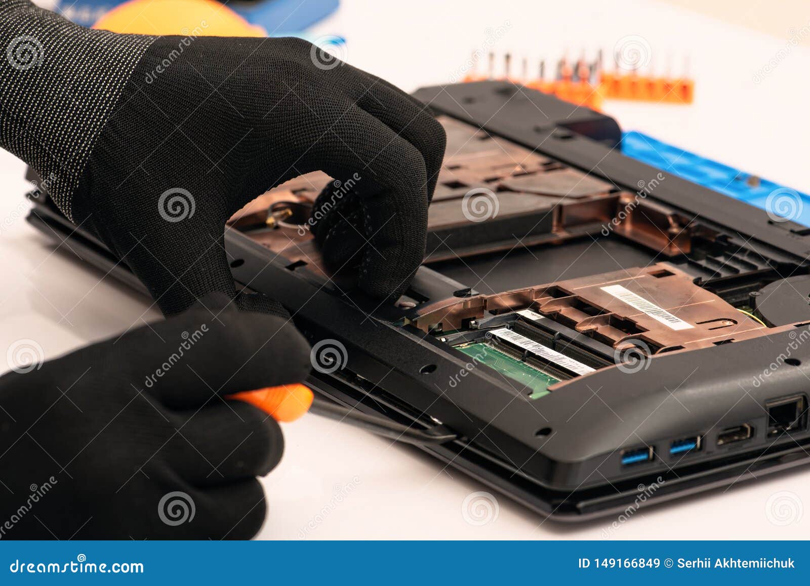 Engineer Dismantles the Details of a Broken Laptop for Repair Stock