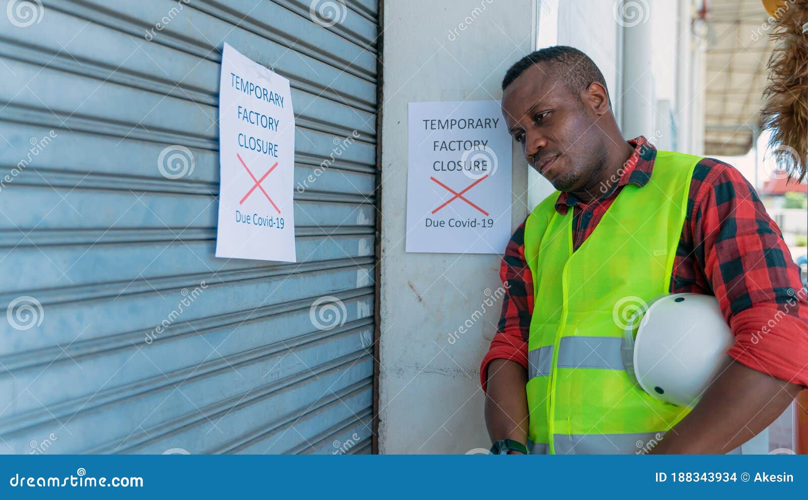 engineer with factory closed notice from coronavirus covid-19 pandemic