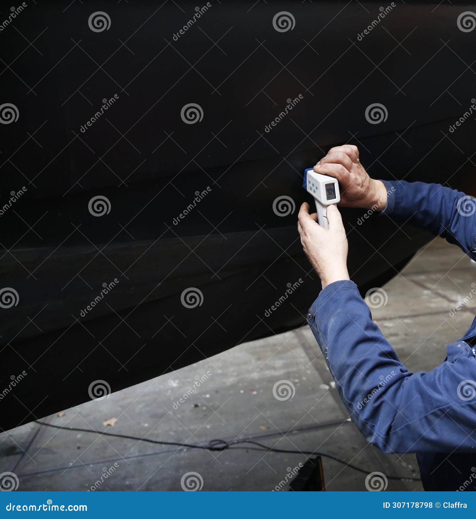 An Engineer Measuring the Thickness of a Steel Hull Stock Photo Image