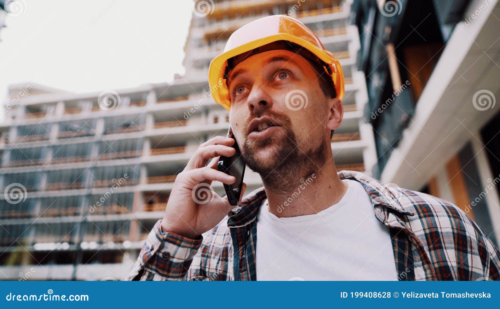 engineer talking on phone. architect using phone on construction site. foreman phone call control process. construction worker