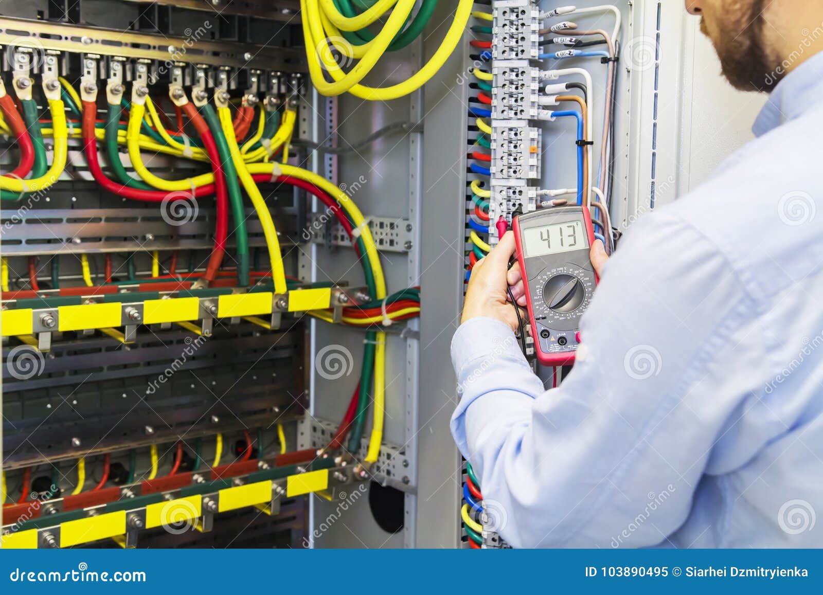 Engineer tests power high voltage three phase circuit box with multimeter. Electric service power system