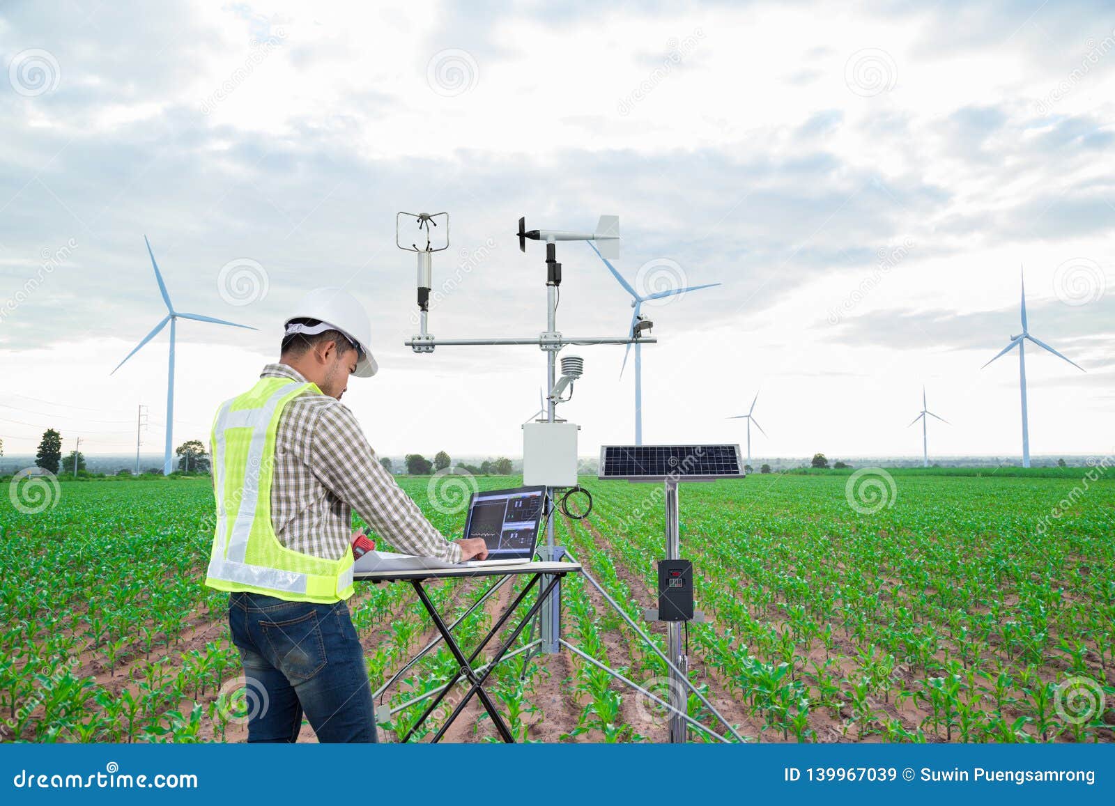 engineer using tablet computer collect data with meteorological instrument to measure the wind speed, temperature and humidity and