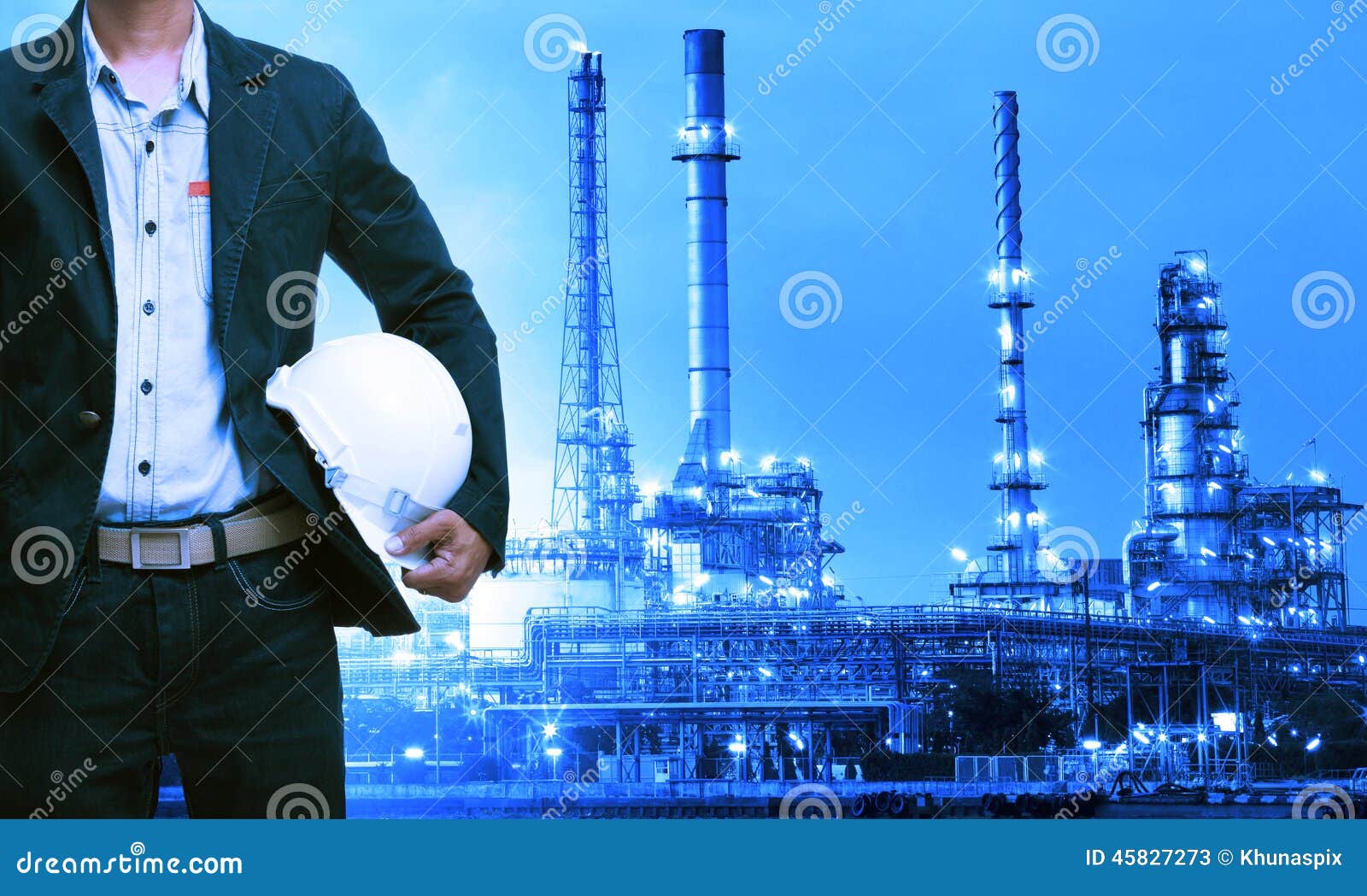 engineering man and safety helmet standing against oil refinery