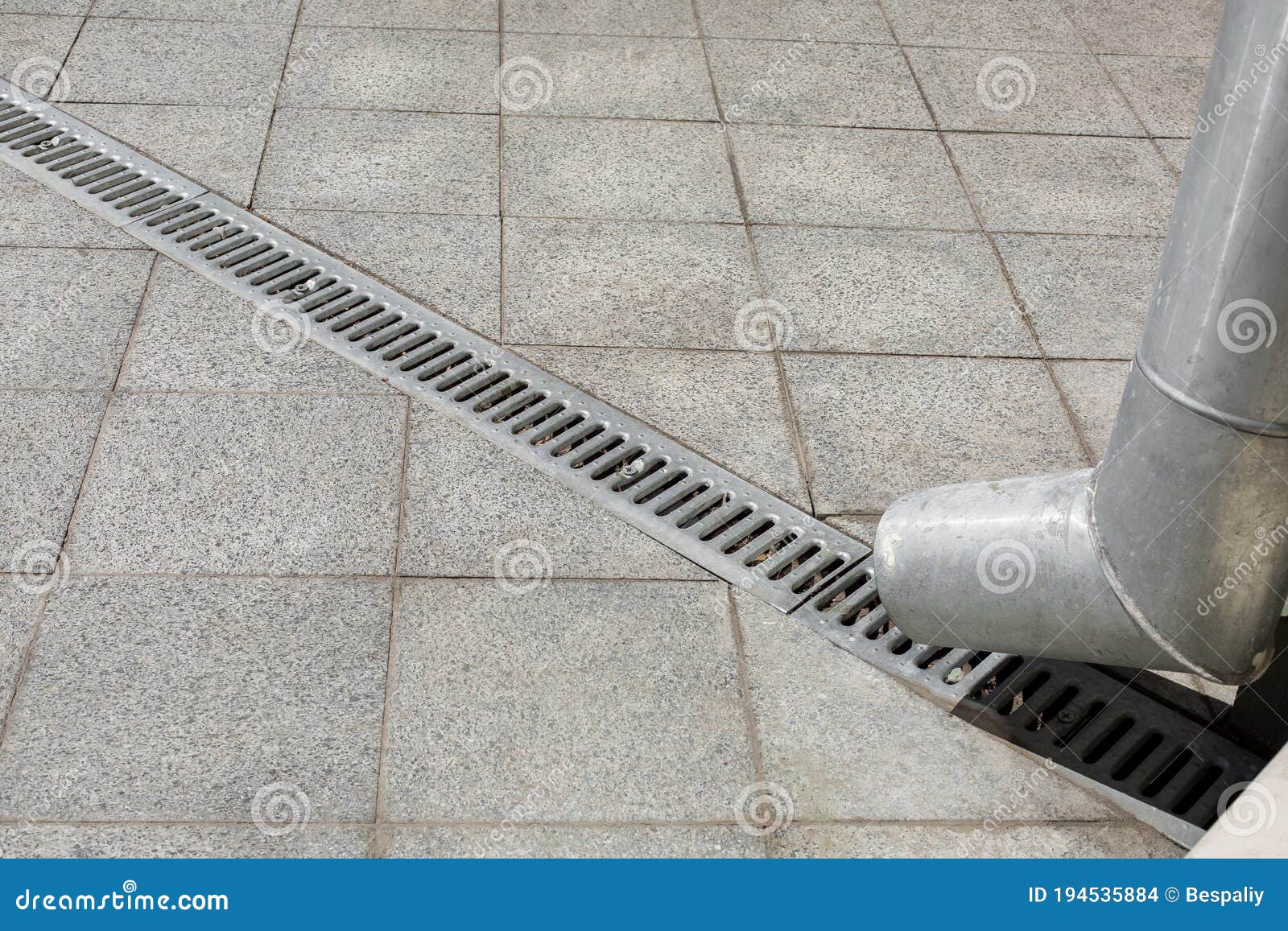 Engineering Structure a Downspout with a Drainage Grate. Stock Photo
