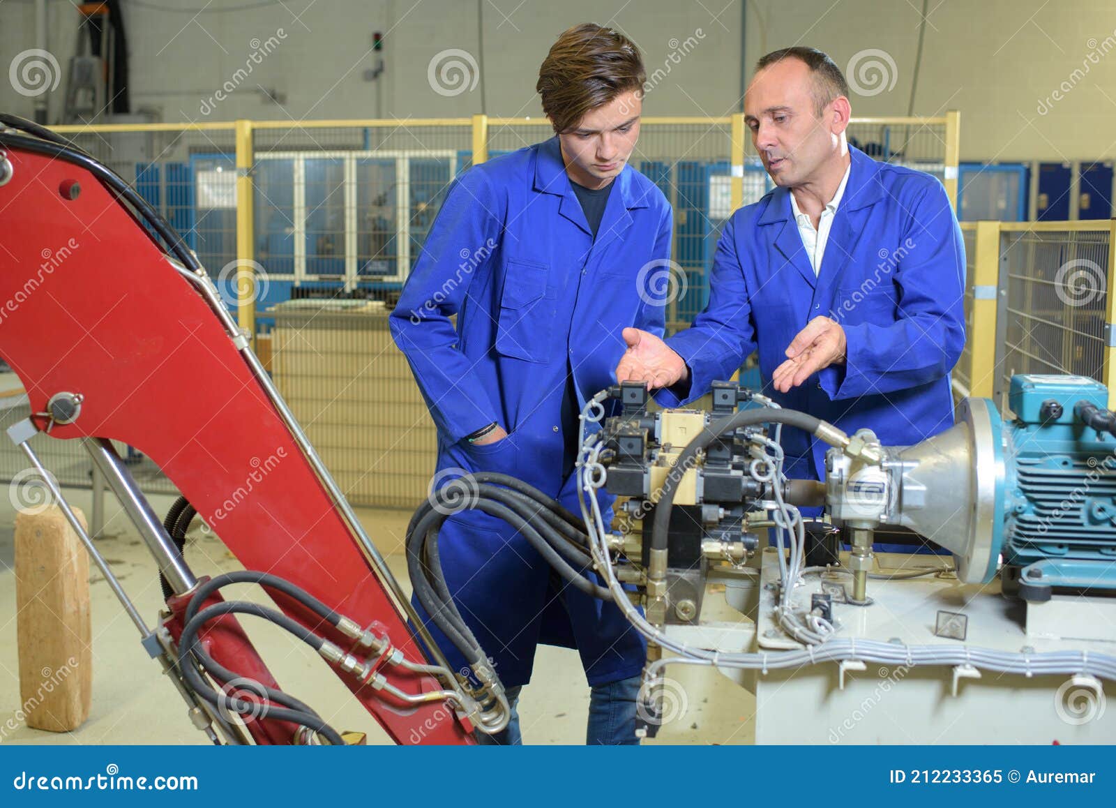 Engineers Looking at Hydraulic Arm Mechanicsm Stock Image Image of