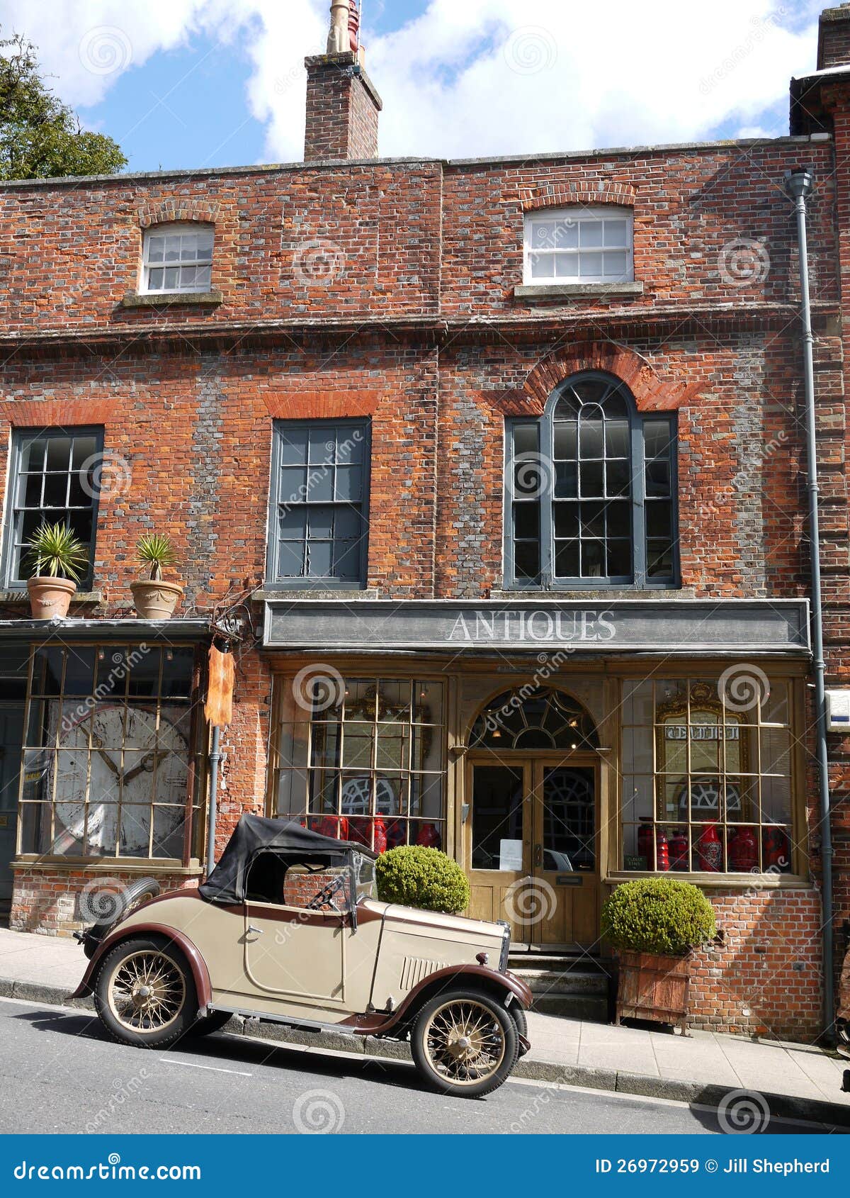 England: Vintage Car and Antiques Shop Stock Image - Image of town