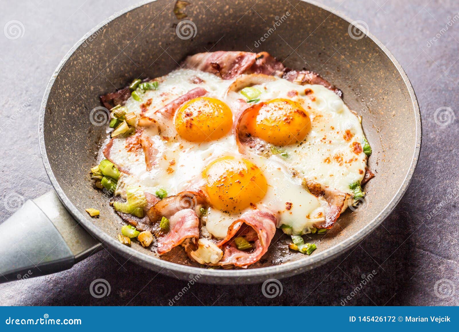 English Breakfast Fried Bacon Ham and Eggs in Ceramic Pan Stock Photo