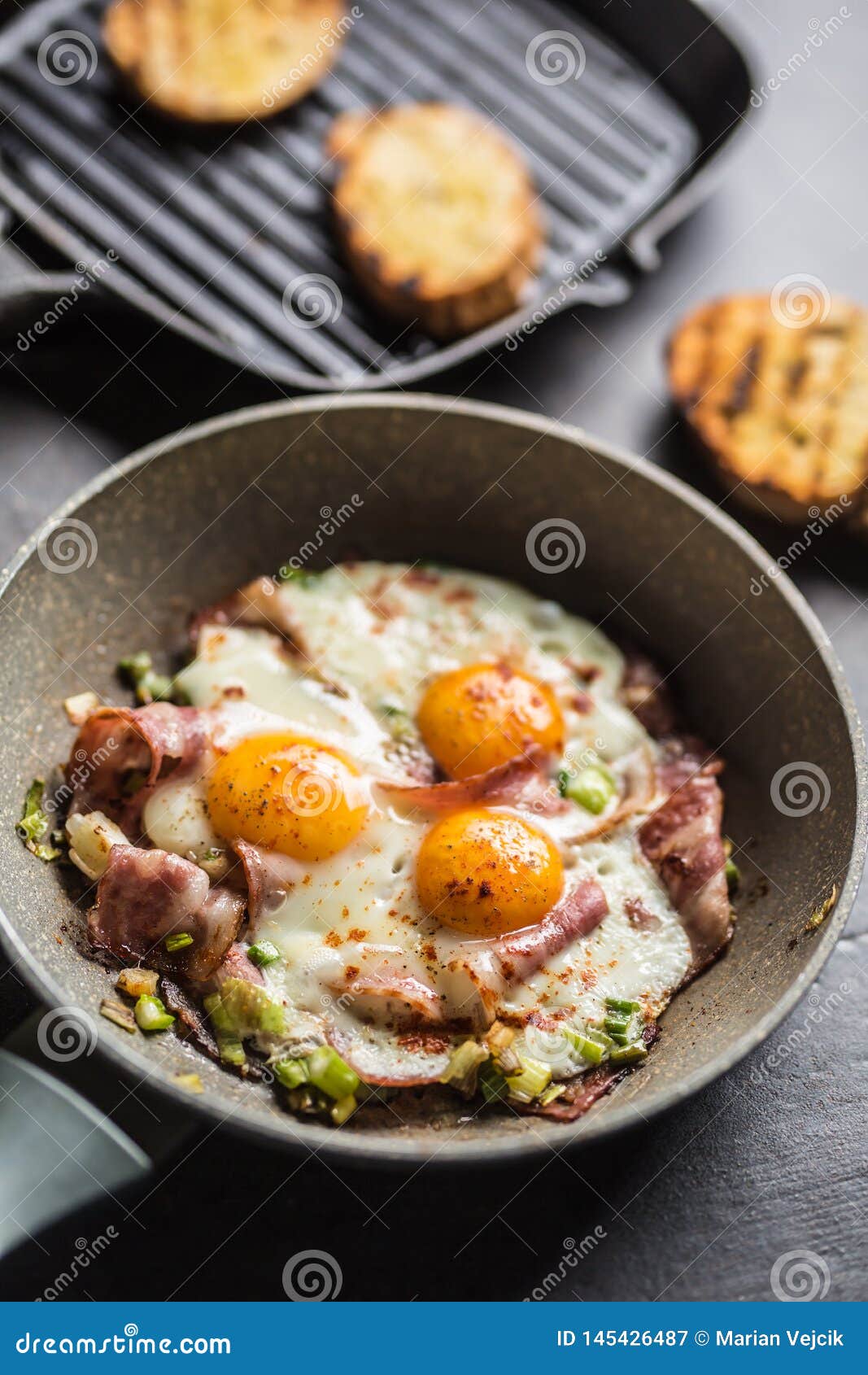 English Breakfast Fried Bacon Ham and Eggs in Ceramic Pan Stock Image