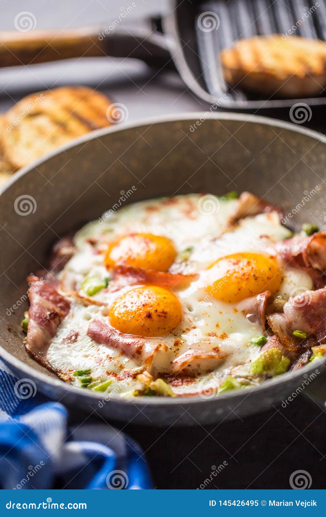 English Breakfast Fried Bacon Ham and Eggs in Ceramic Pan Stock Image