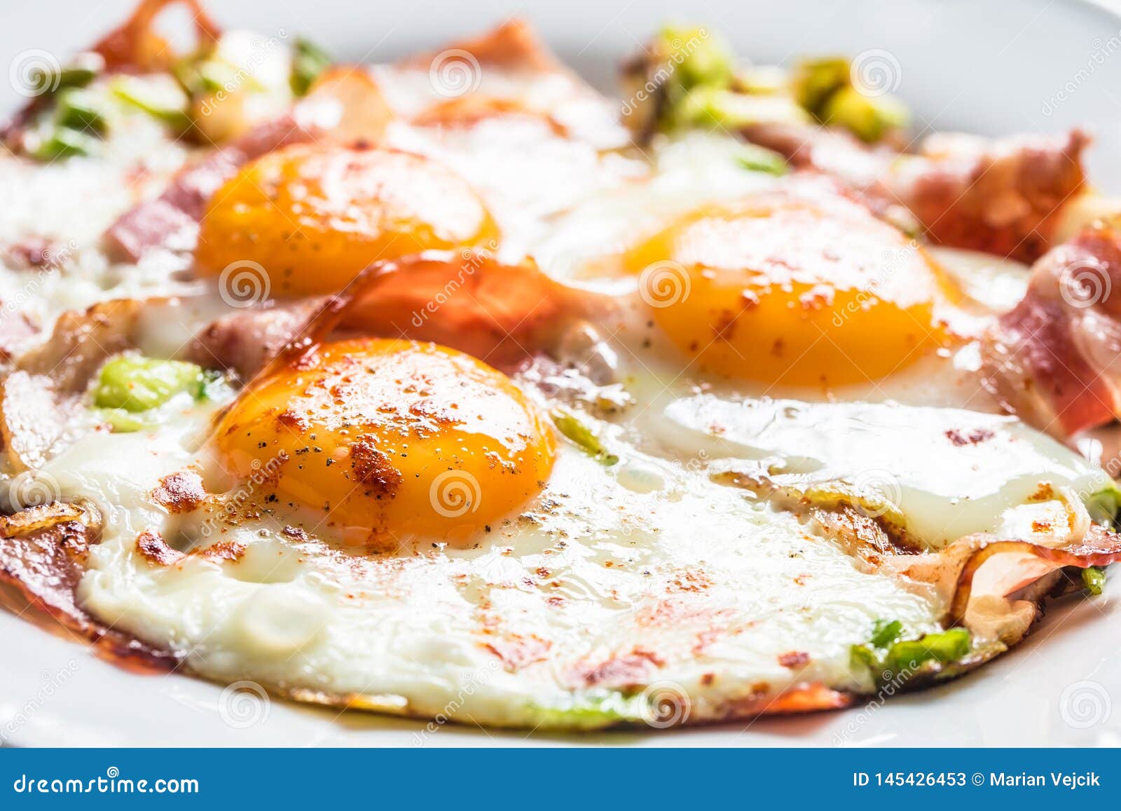 English Breakfast Fried Bacon Ham and Eggson White Plate Stock Image