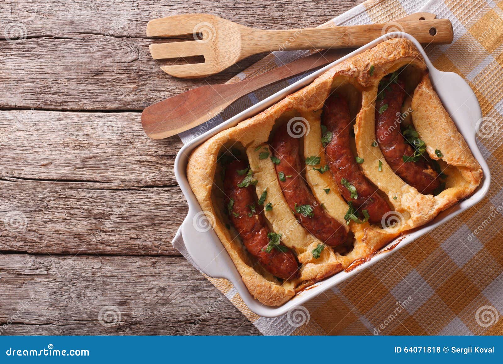 English Food Toad in the Hole into a Baking Dish. Horizontal To Stock