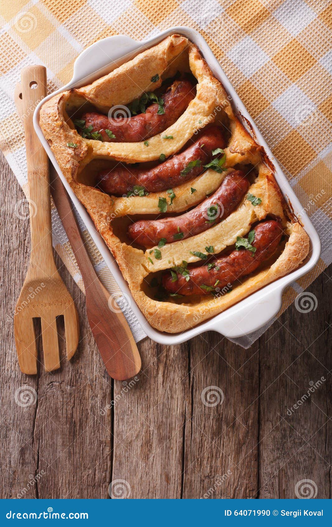 English Food Toad in the Hole into a Baking Dish. Vertical Top Stock