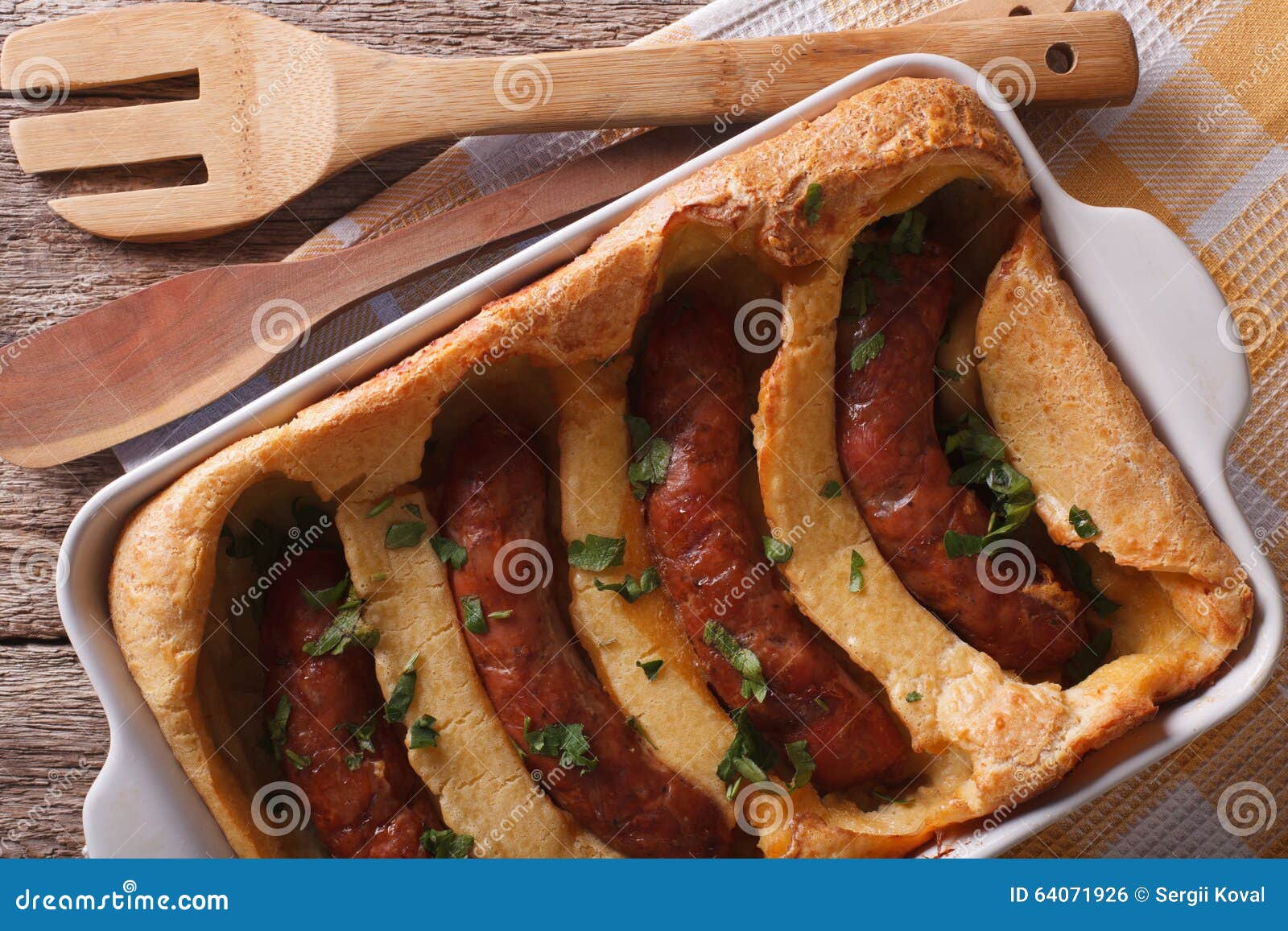 English Toad in the Hole into a Baking Dish Close Up. Horizontal Stock
