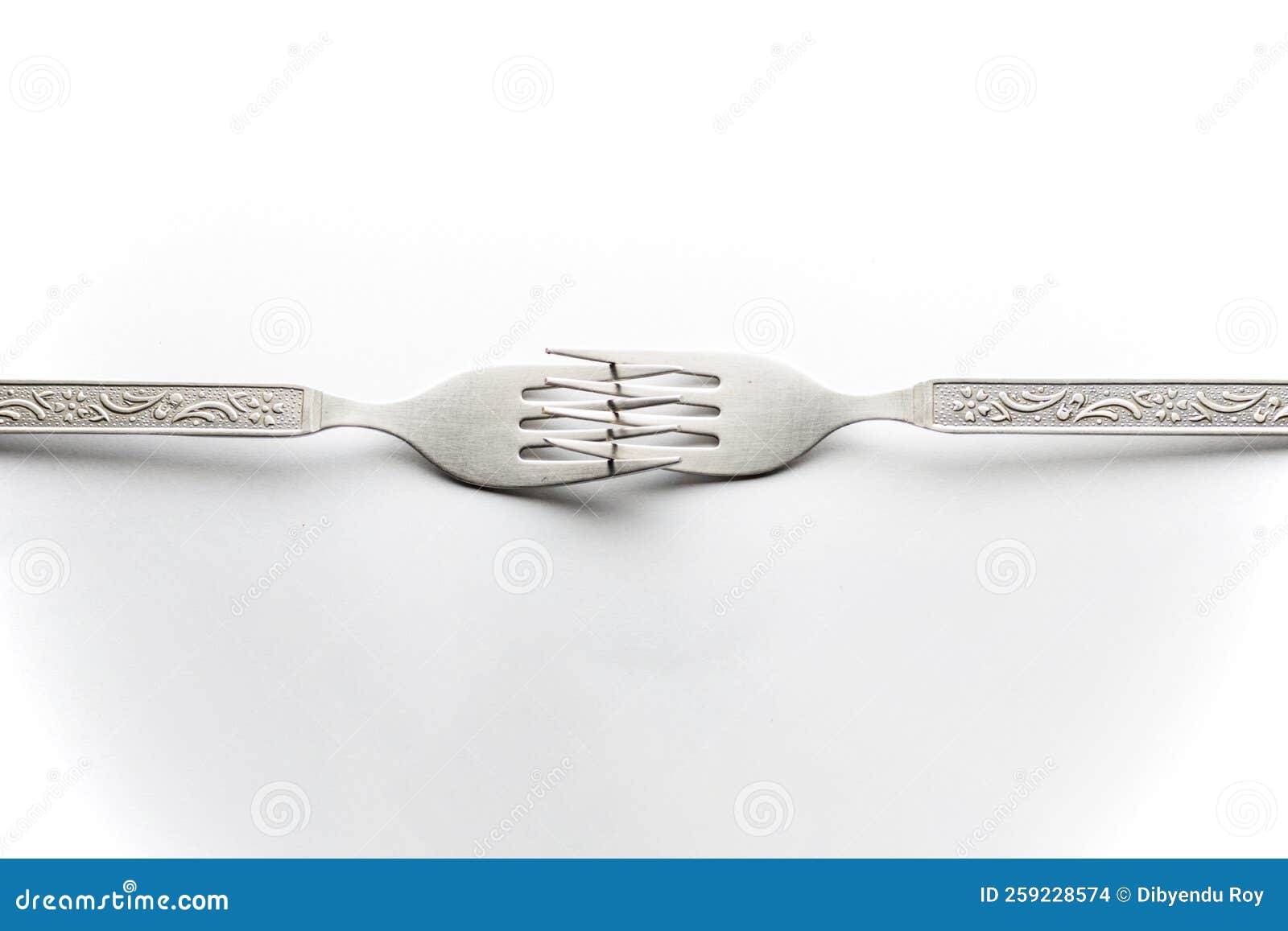 Engraved Silverware Fork Set of Two Placed Face To Face Crossing Their