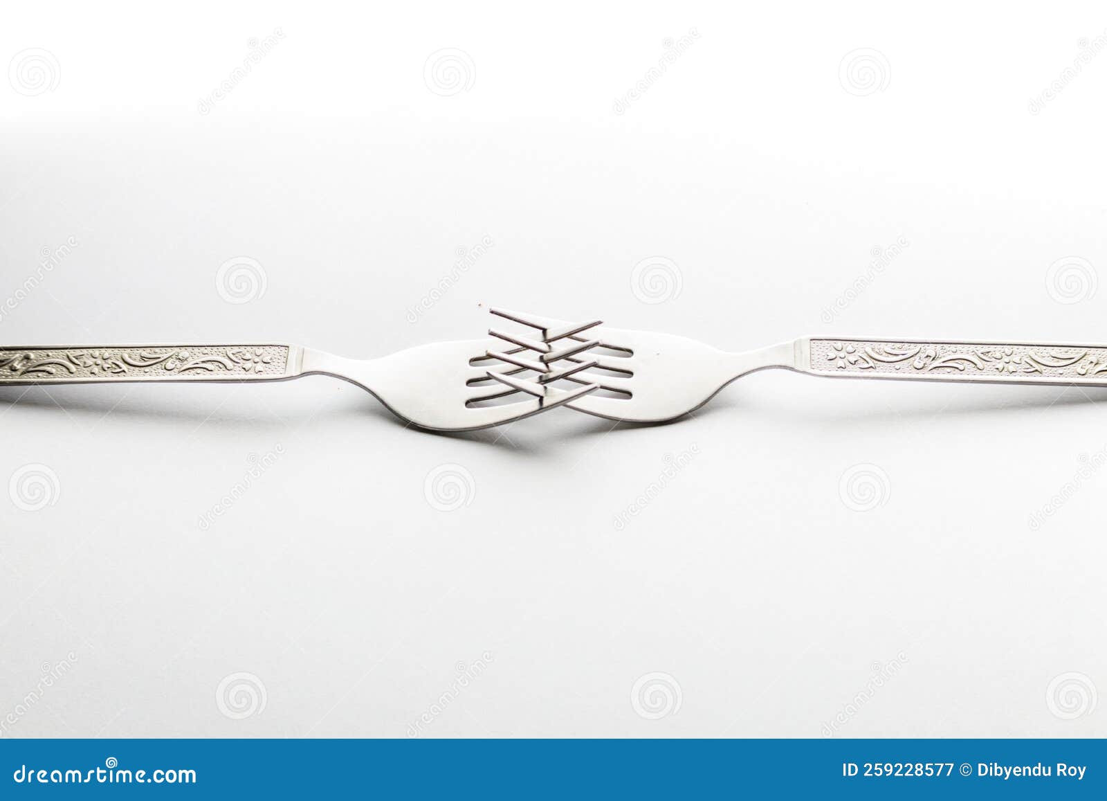 Engraved Silverware Fork Set of Two Placed Face To Face Crossing Their