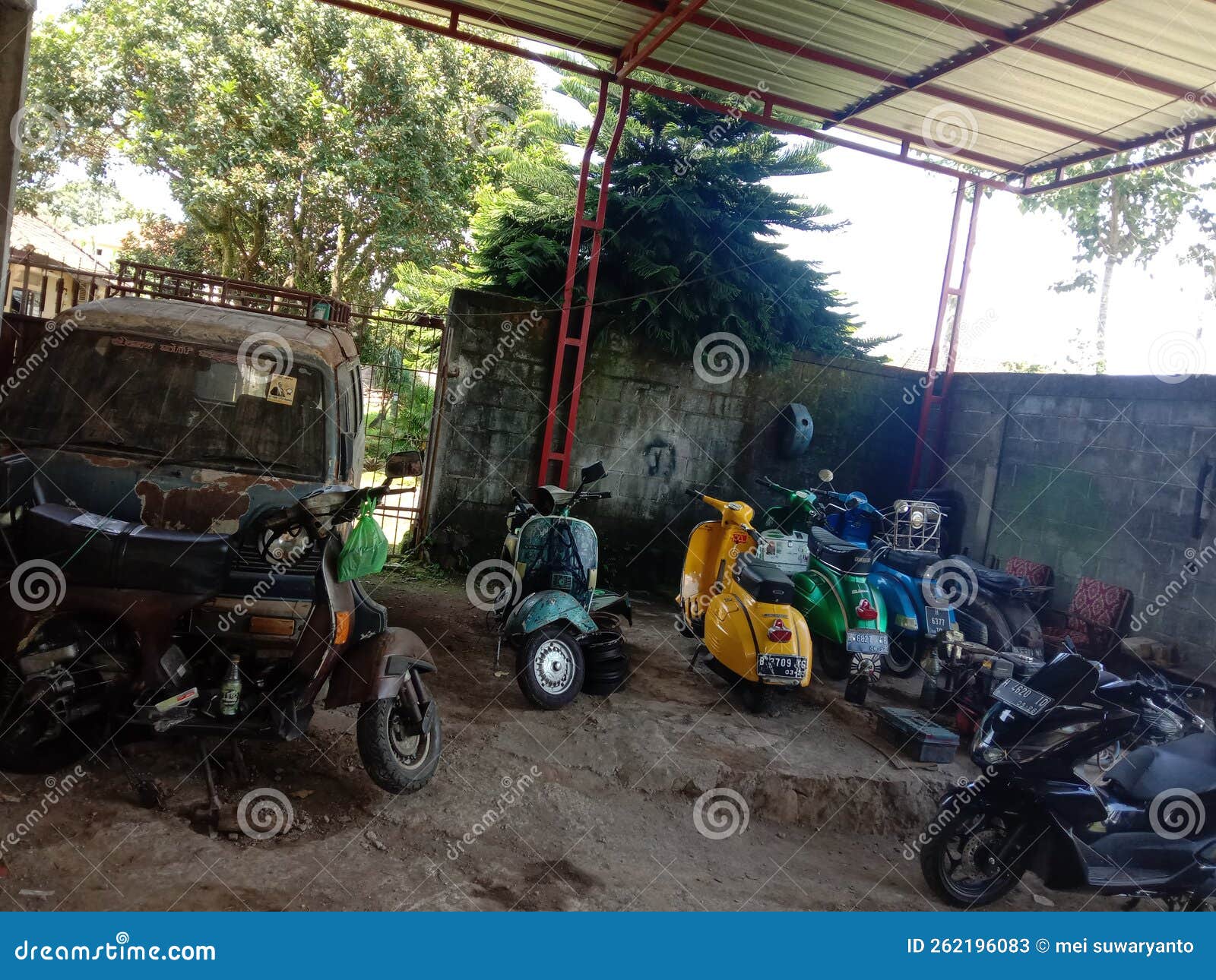 Scooter Garage In The Facade In Front Of A Medieval Fountain Editorial