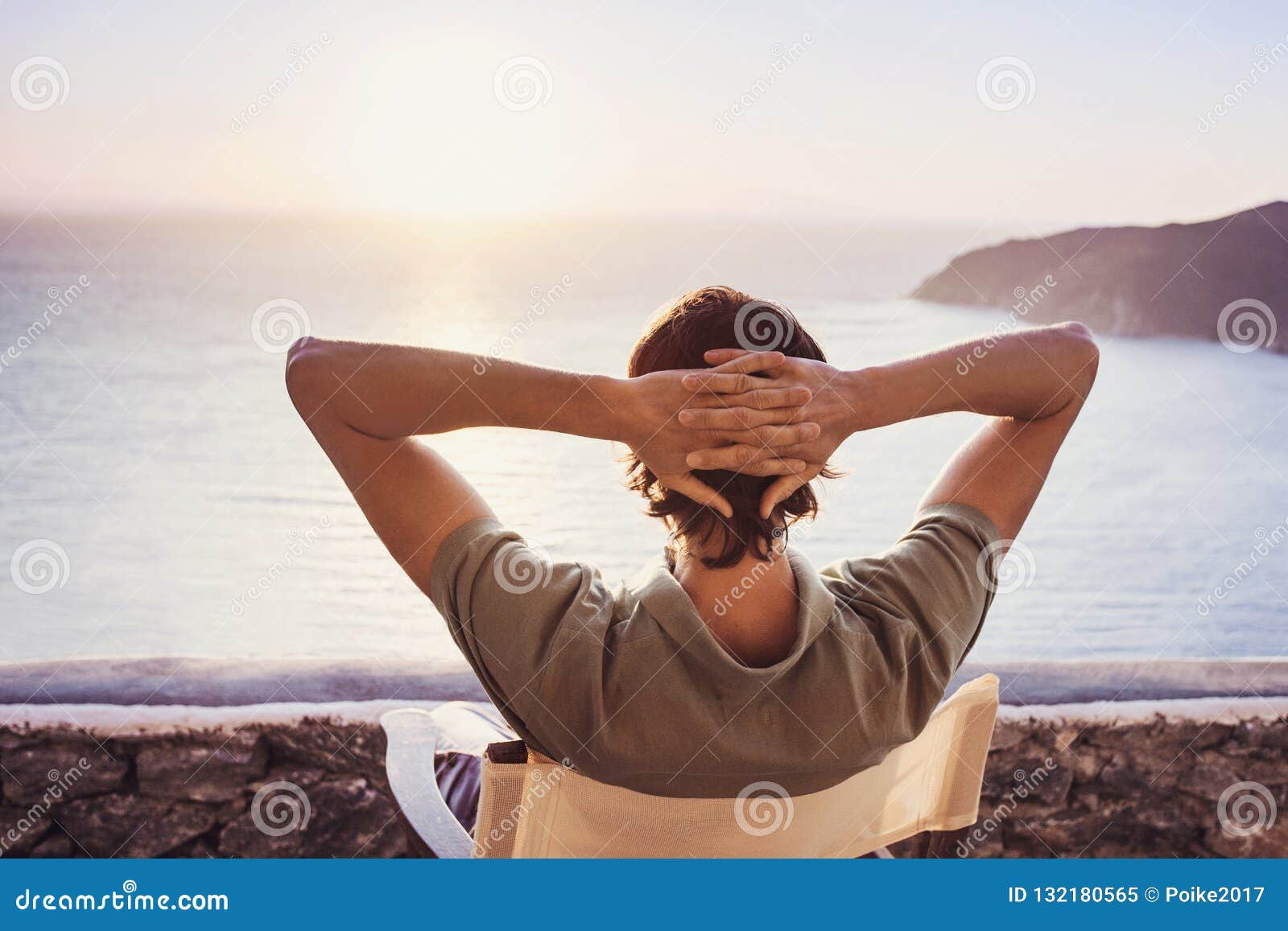 Enjoying life. Back side of young man looking at the sea, vacations  lifestyle, mindfulness, summer fun concept Stock Photo