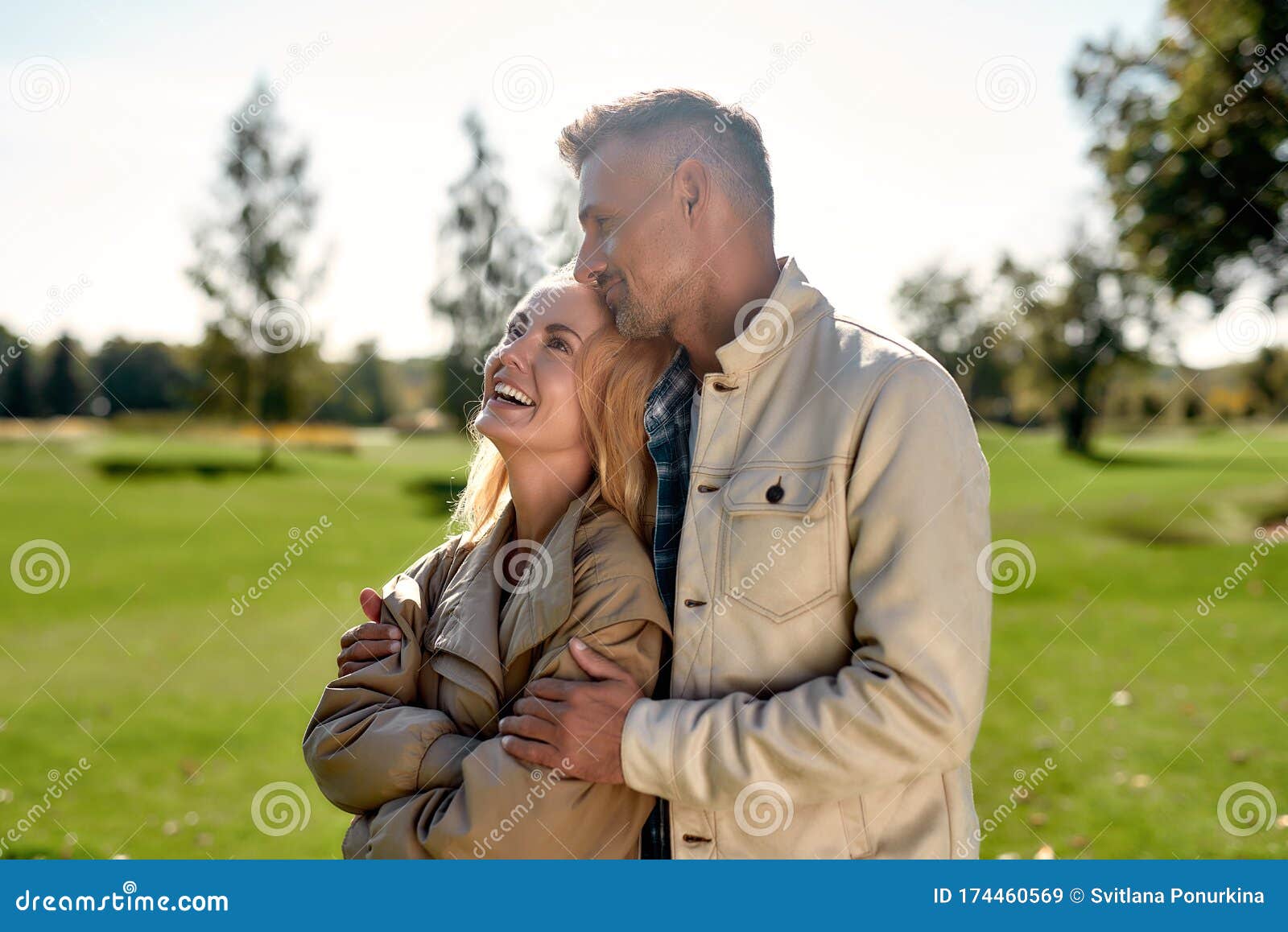 Young Couple In Love Standing Outside In Spring Nature 