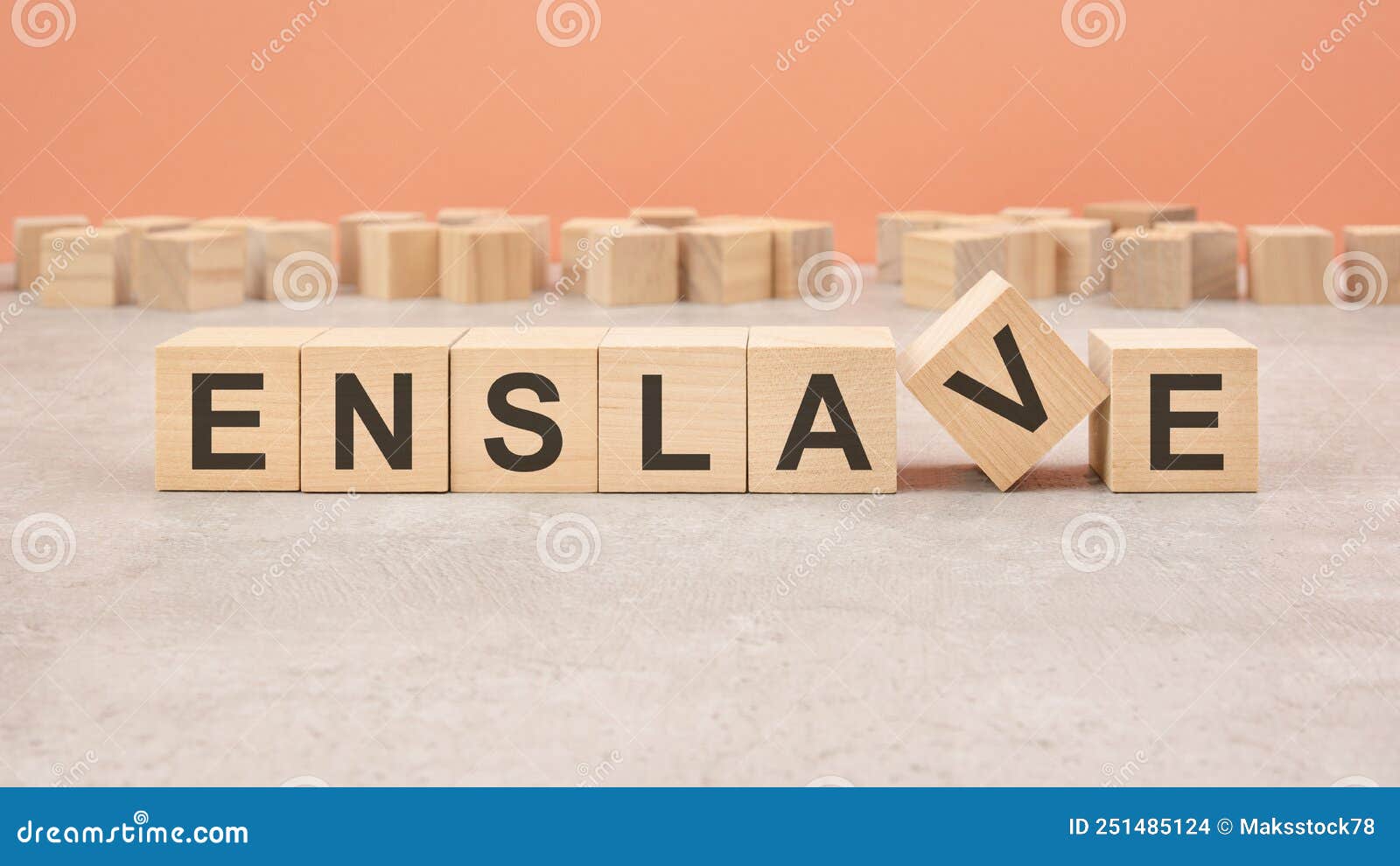 enslave word written on wood block - text on wooden table for your desing, concept.