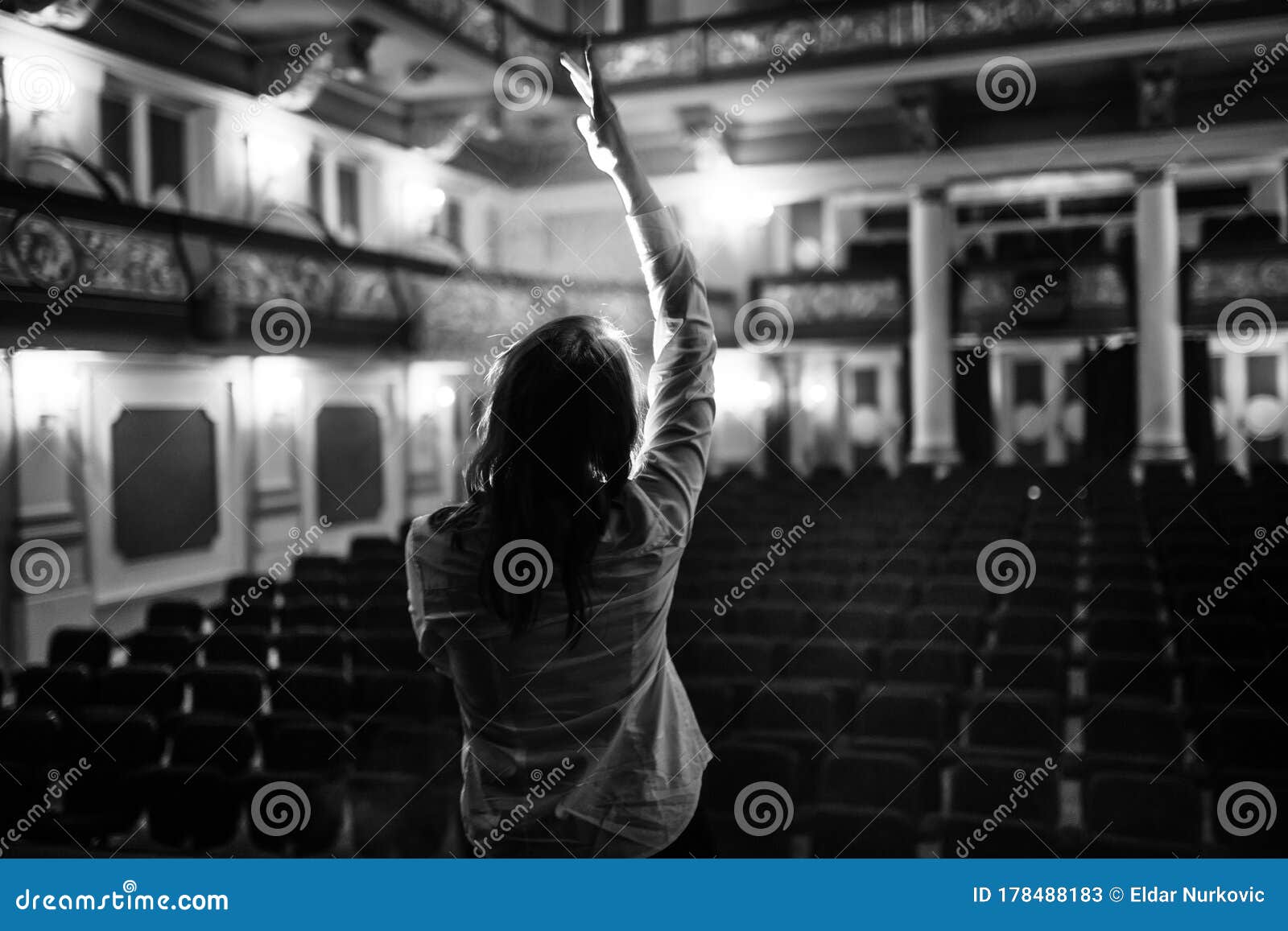 entertainer performing on a stage in a empty theater,concert hall without fans