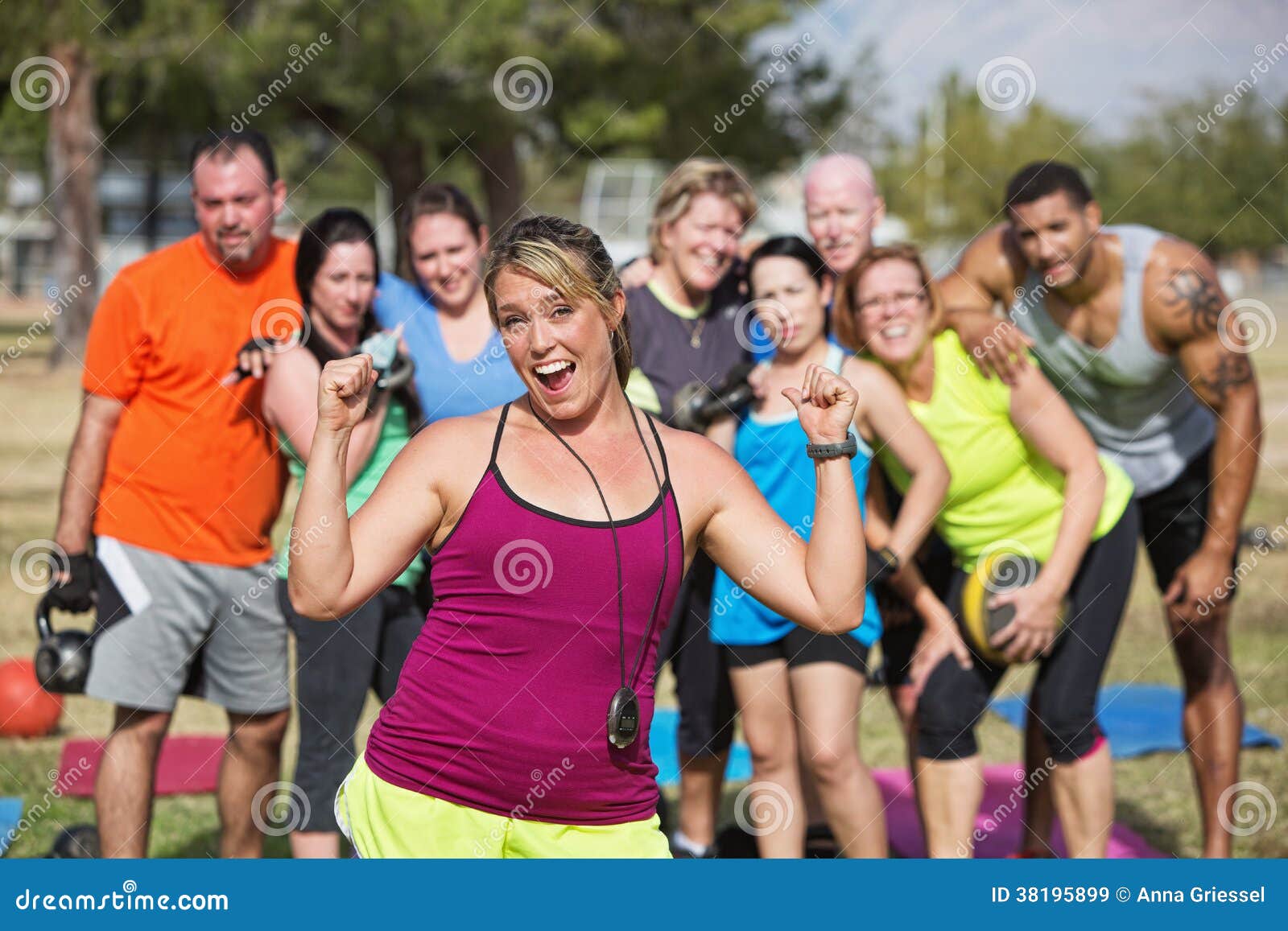 enthusiastic fitness instructor with group