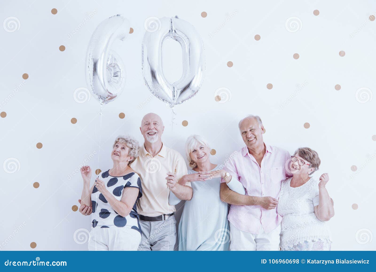 enthusiastic seniors with silver balloons