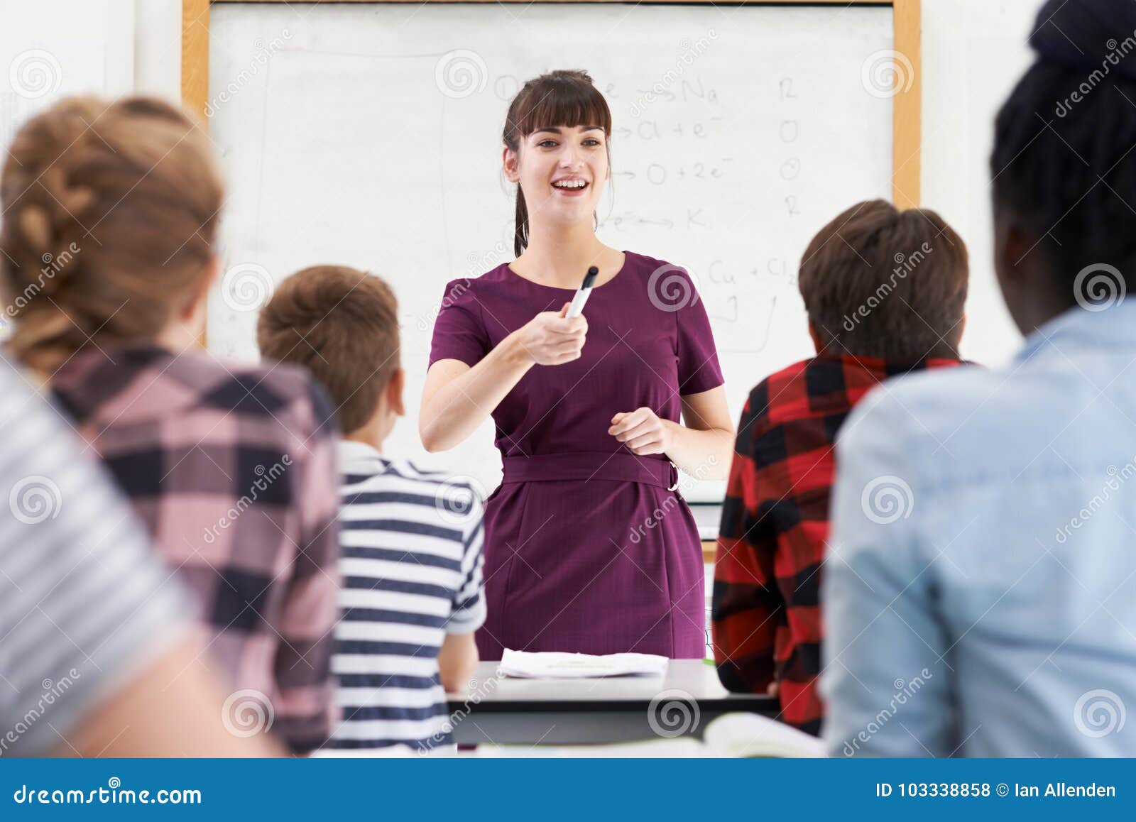 enthusiastic teacher with class of teenage students