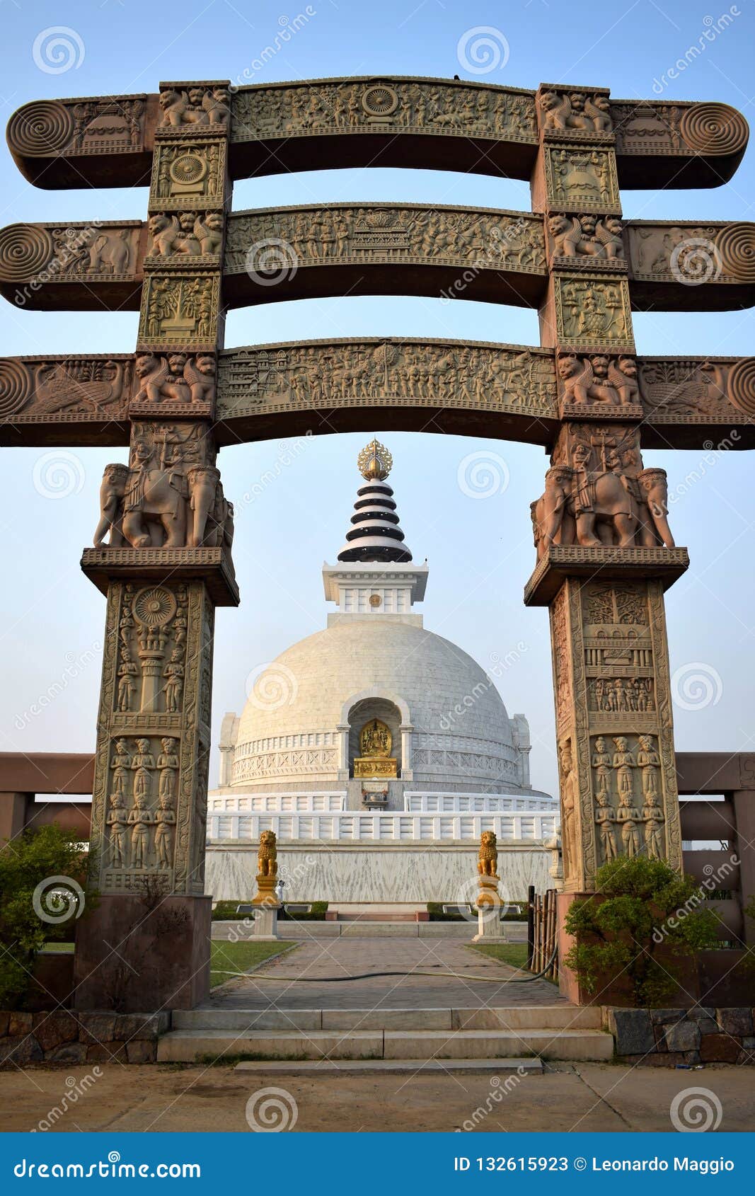 entrance arch to the stupa shanti with the stupa in the background in delhi