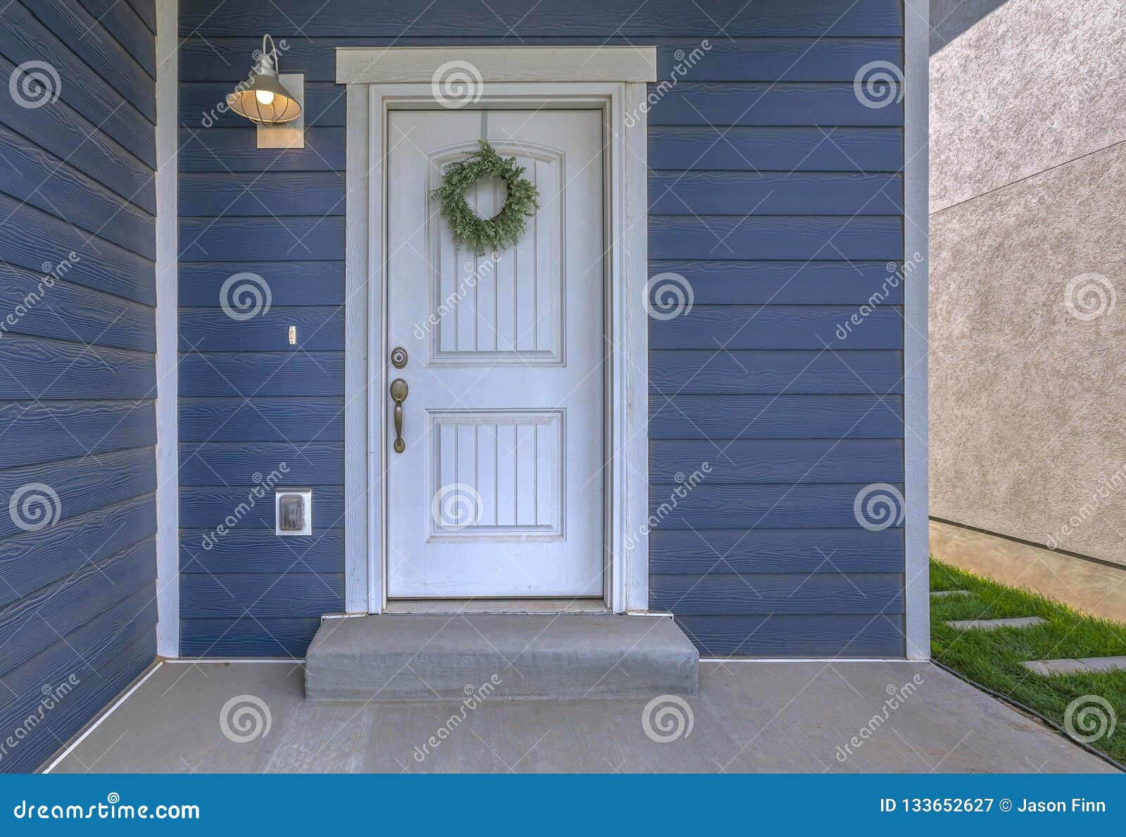 entrance of a home with blue wall and white door