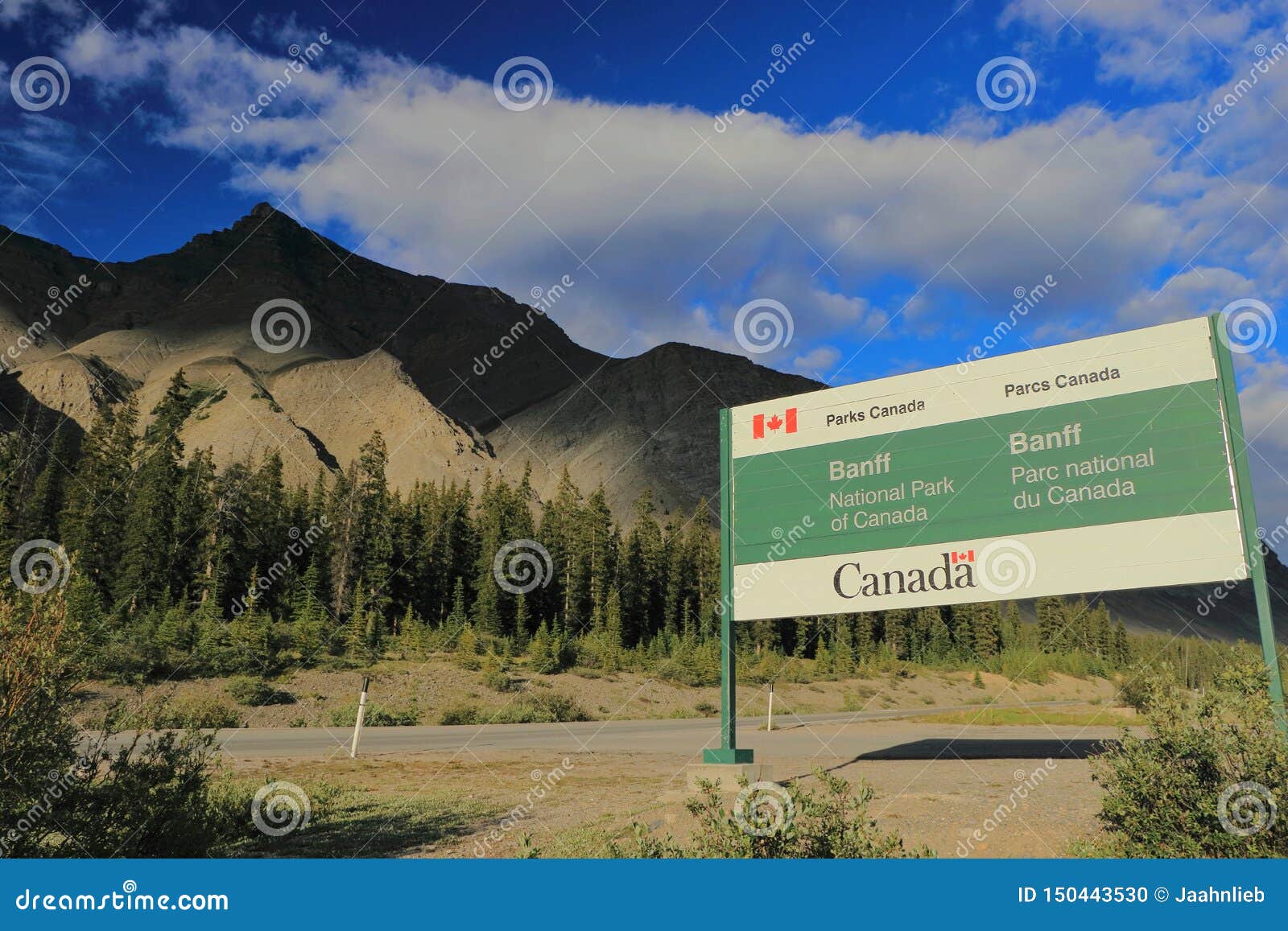 parks canada entrance sign at sunwapta pass along icefields parkway inevening light, banff national park, alberta