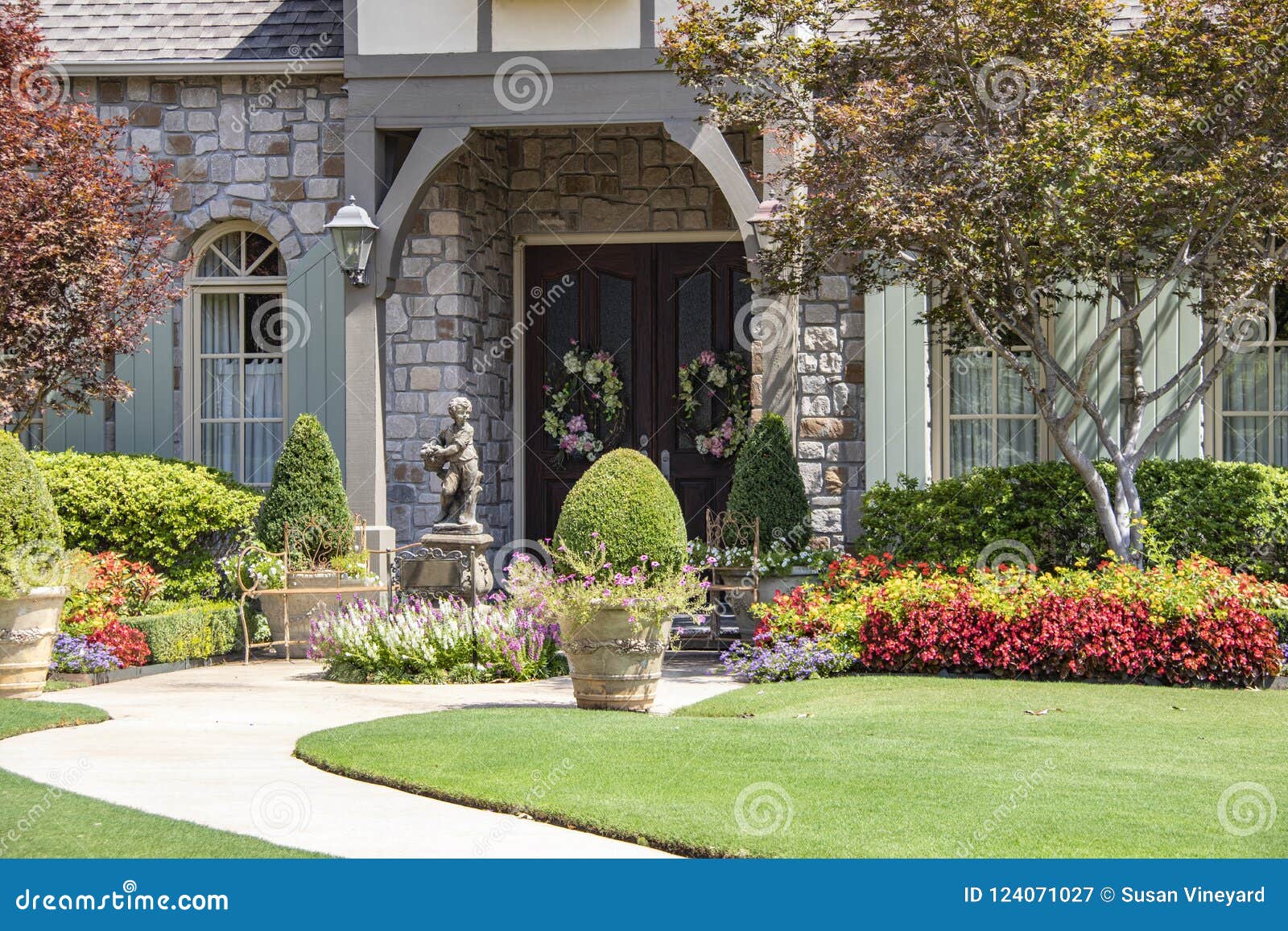 Entrance To Upscale Rock House With Beautiful Landscaping And A