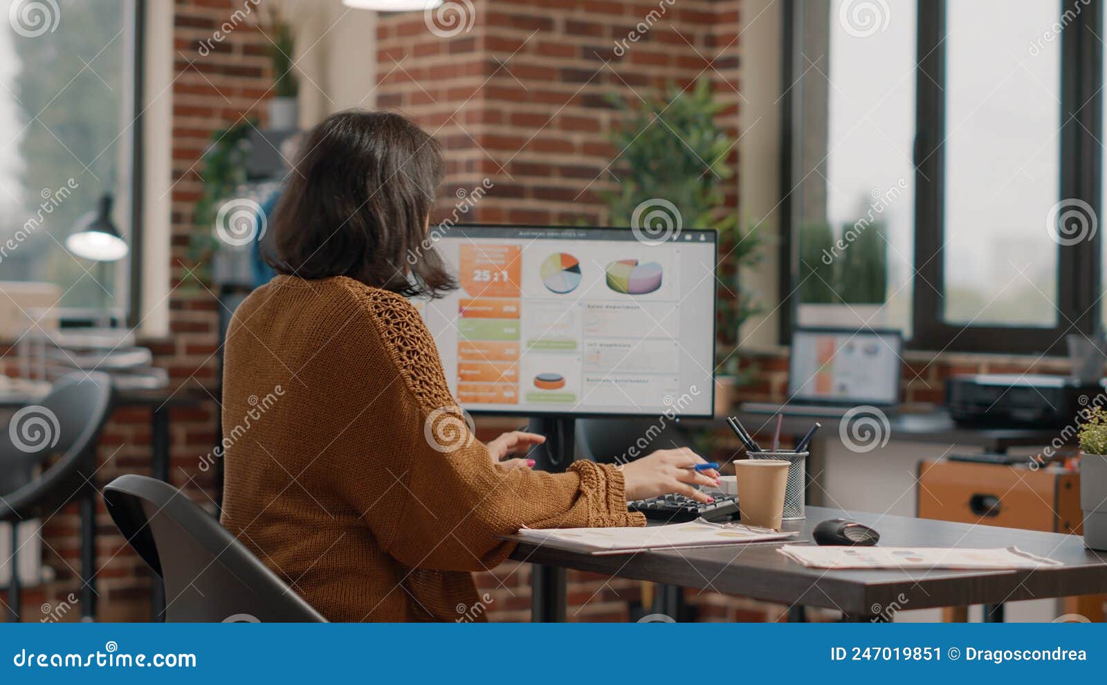 entrepreneur sitting at desk and working on data rate charts