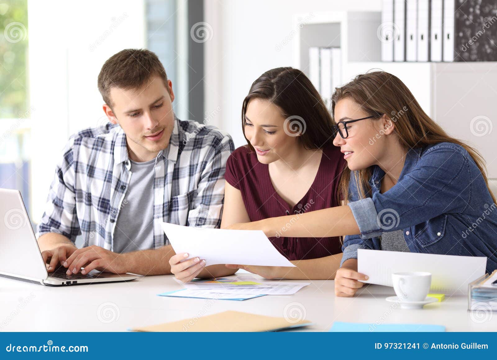 entrepreneurs analyzing a report at office