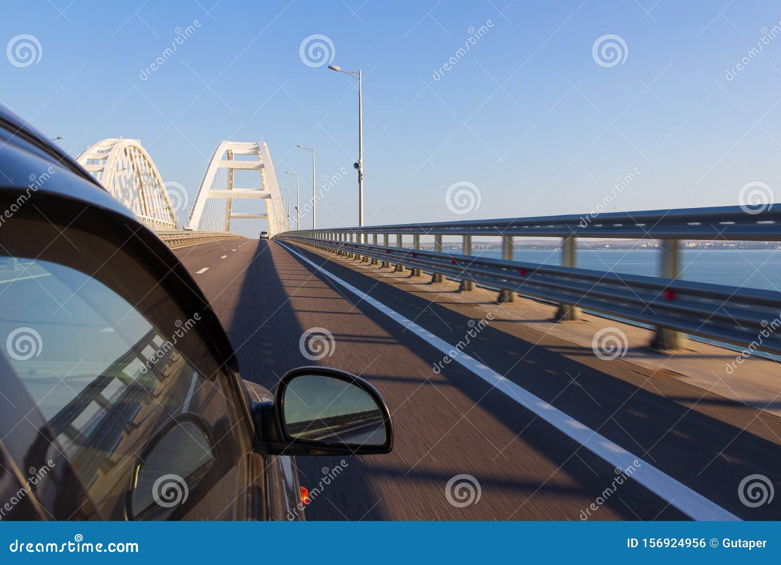 entry to the crimean bridge by car, view of the crimean bridge from the window of a moving car in the summer morning.