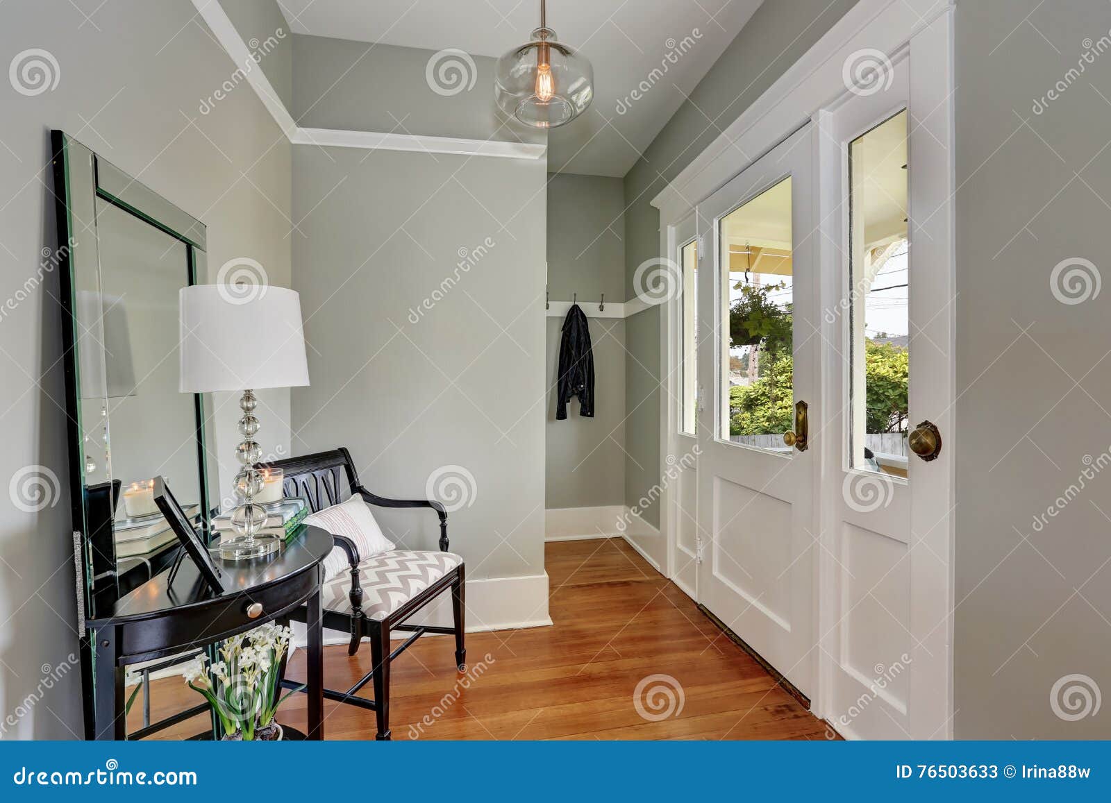 entryway with gray walls, console table and wood floors