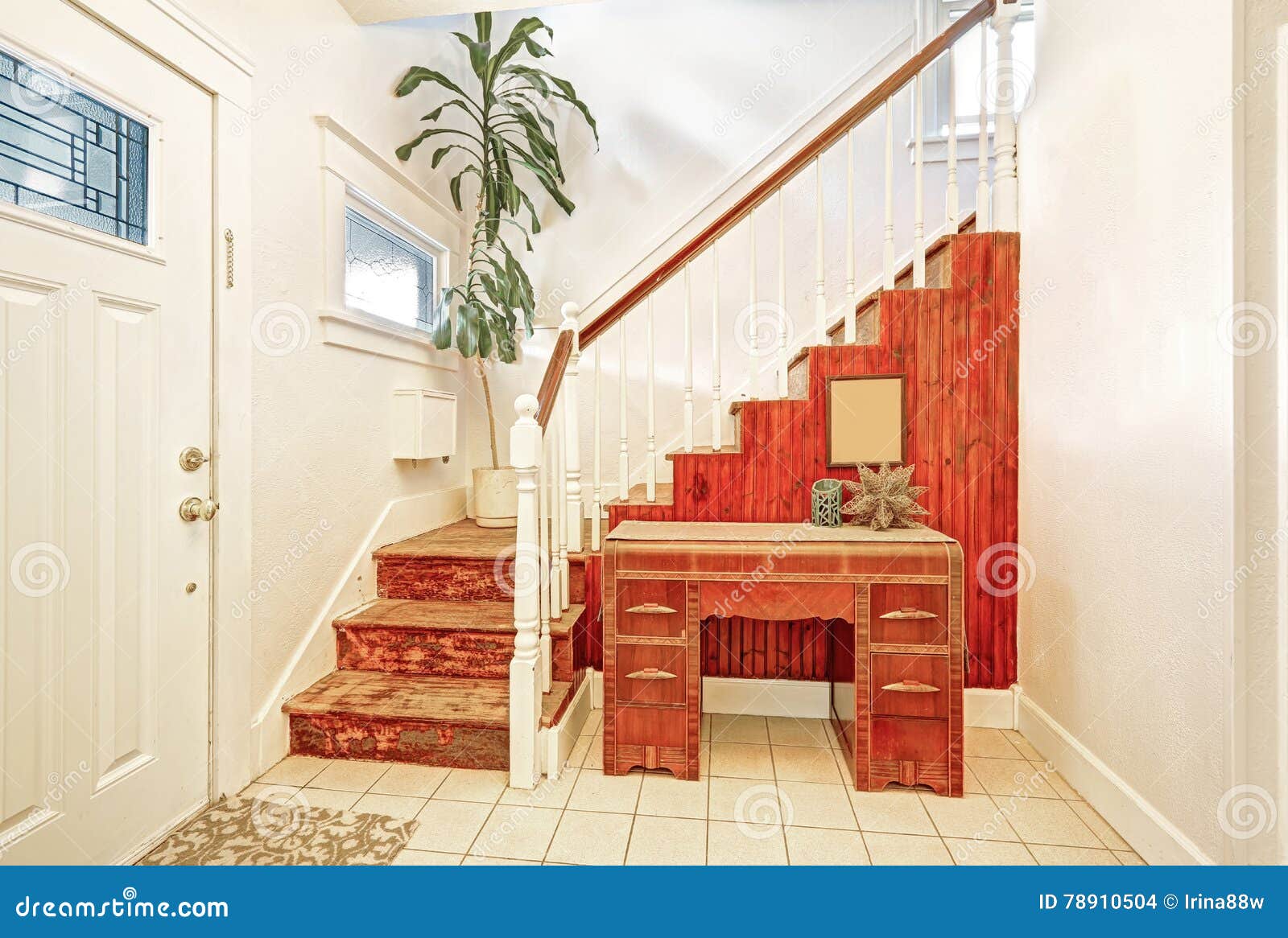 Entryway With Tile Floor Staircase And Vintage Console Table